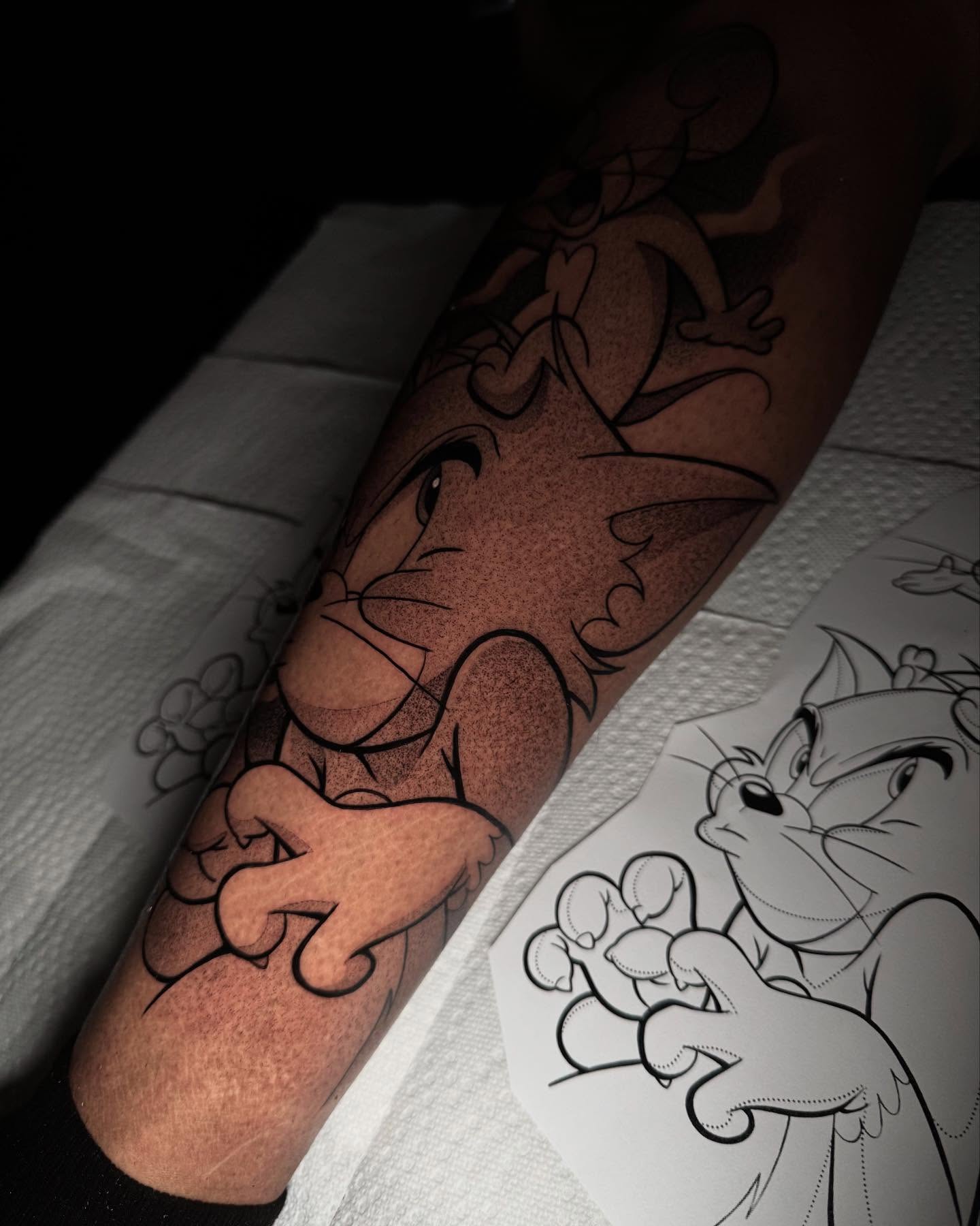 Tom and jerry dotwork tattoo on the forearm by Anthony D. Rustik