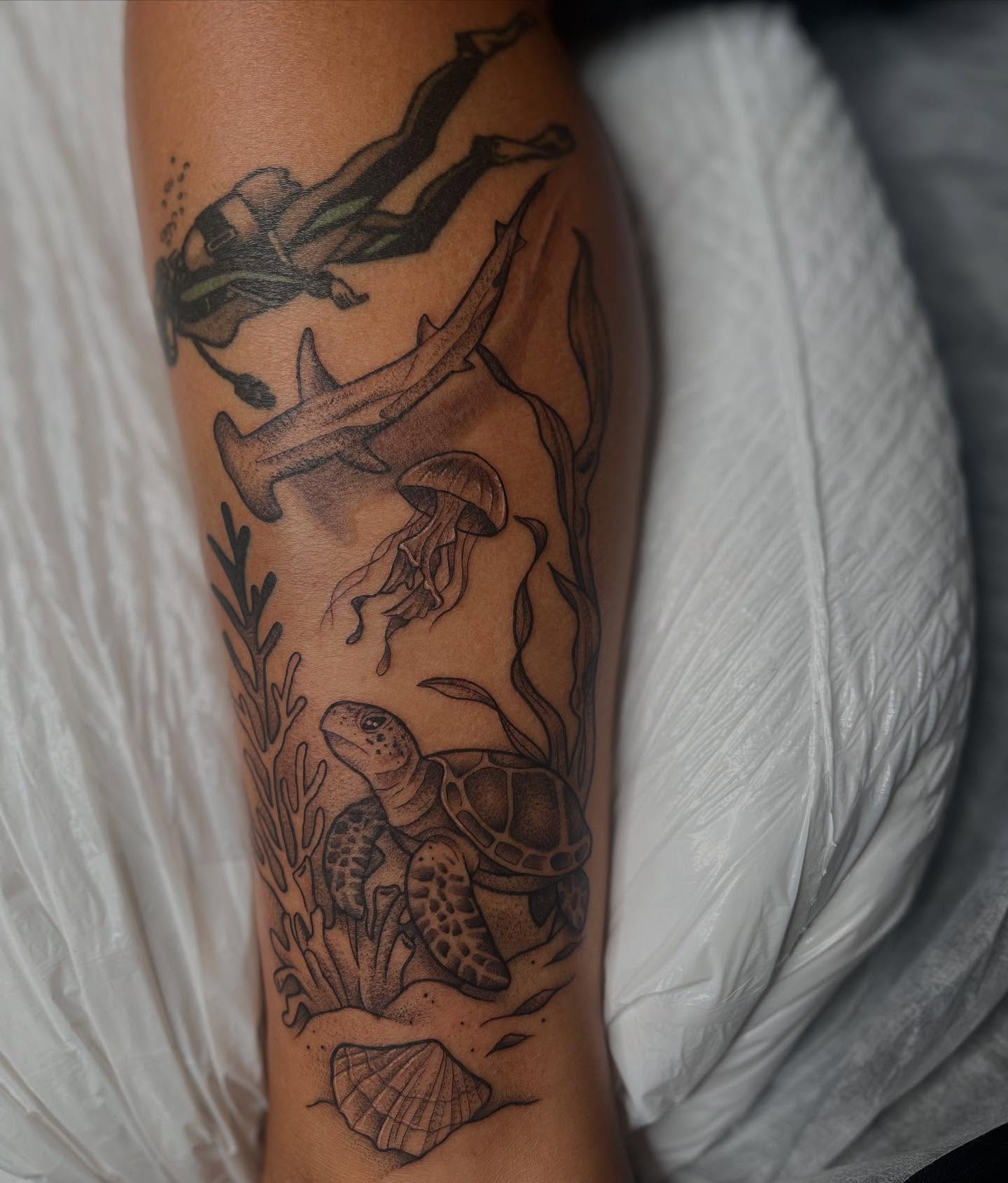 Underwater scene realism tattoo on the forearm by Lexi Ross
