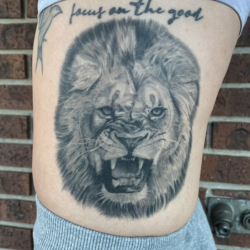 Lion realism tattoo on the thigh by Jeremiah Warner