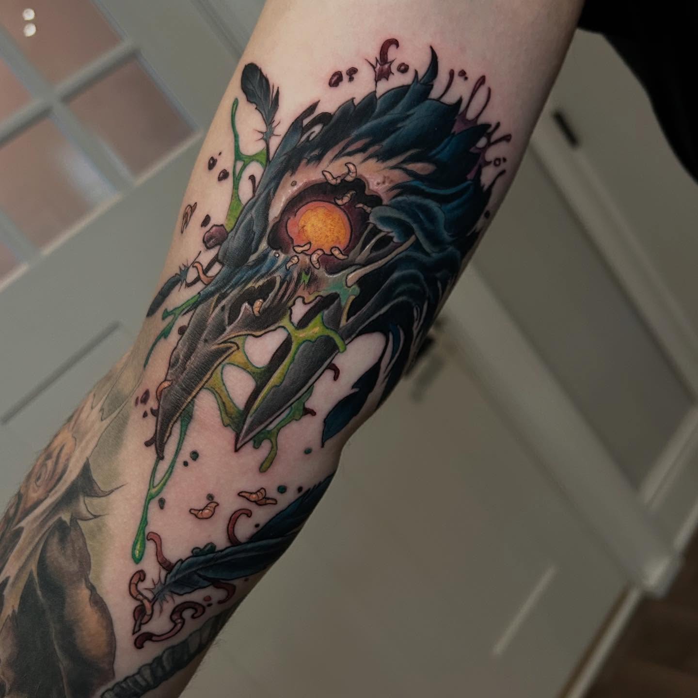 Feathered bird American traditional tattoo on the forearm by Marvin Silva