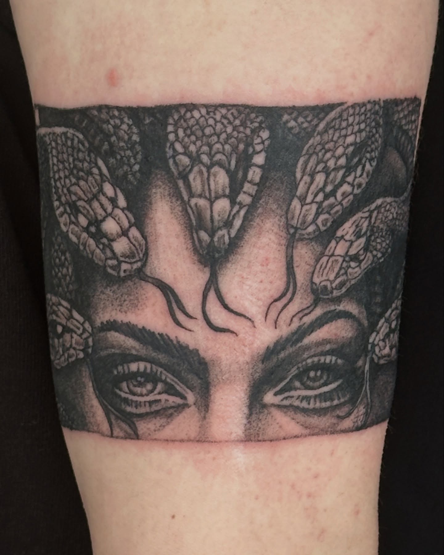 Medusa portrait realism tattoo on the forearm by Matthew Tattooer Harman
