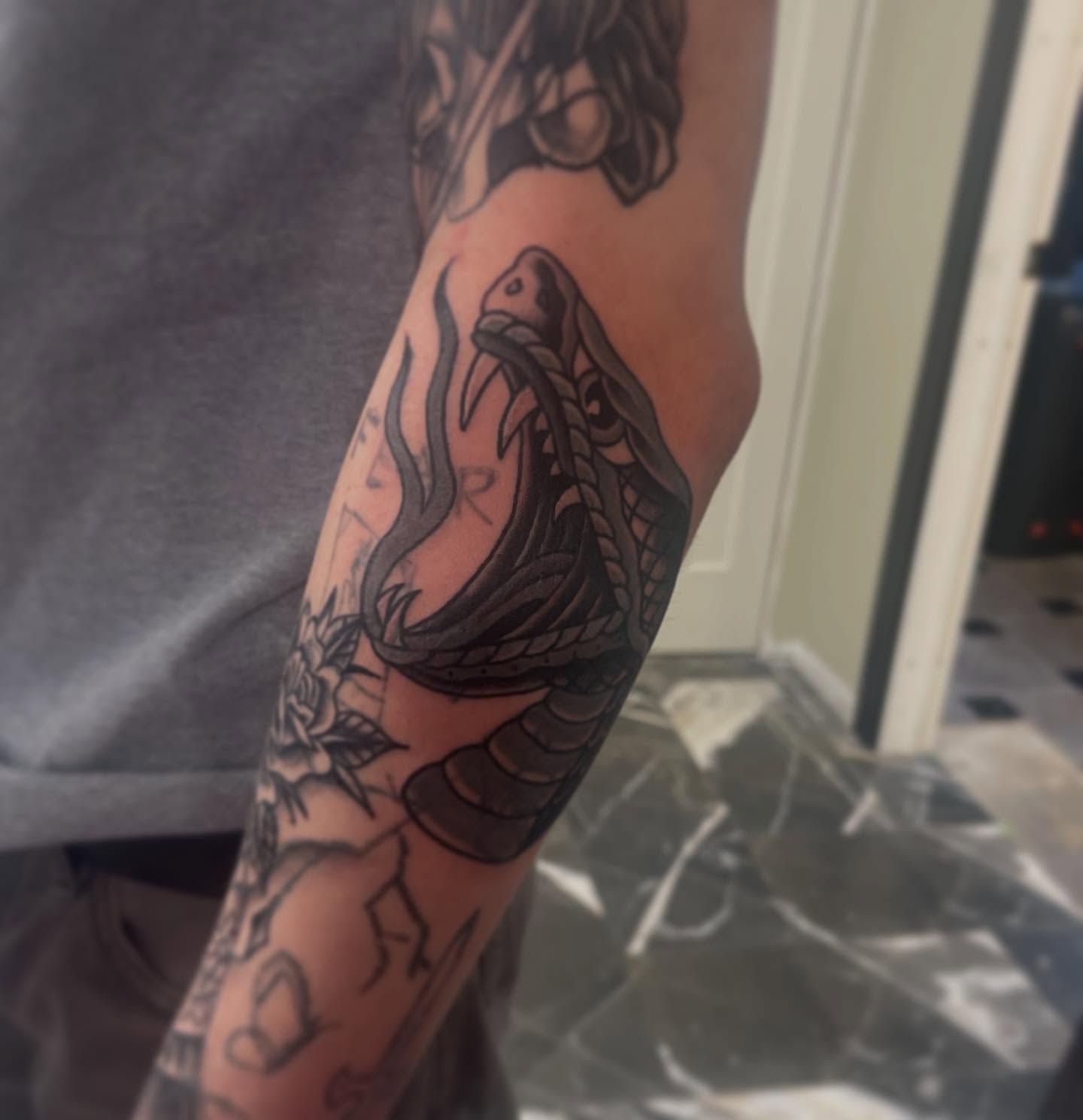 Snake black and grey tattoo on the forearm by Jaxson Eugene Brady-Hobart