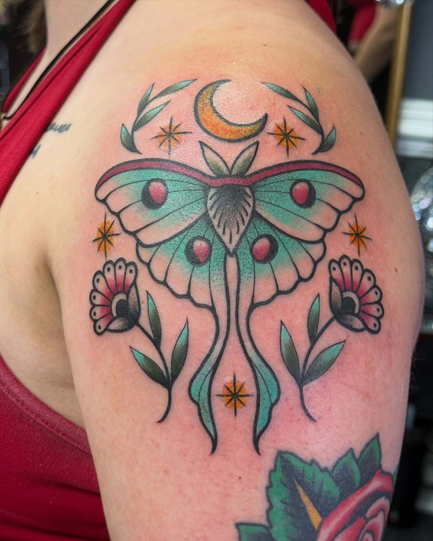 Moon moth and flowers American traditional tattoo on the shoulder by jenna clark🎨