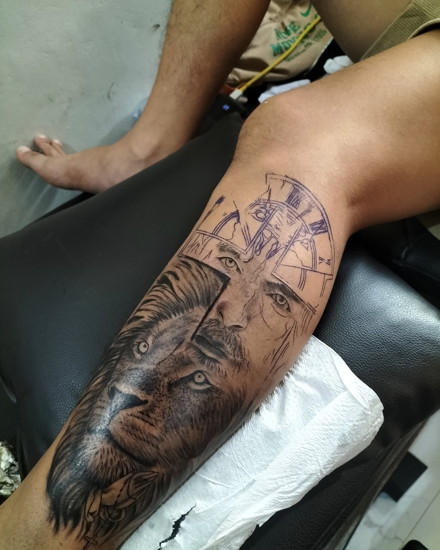 Lion and man realism tattoo on the forearm by Peter John