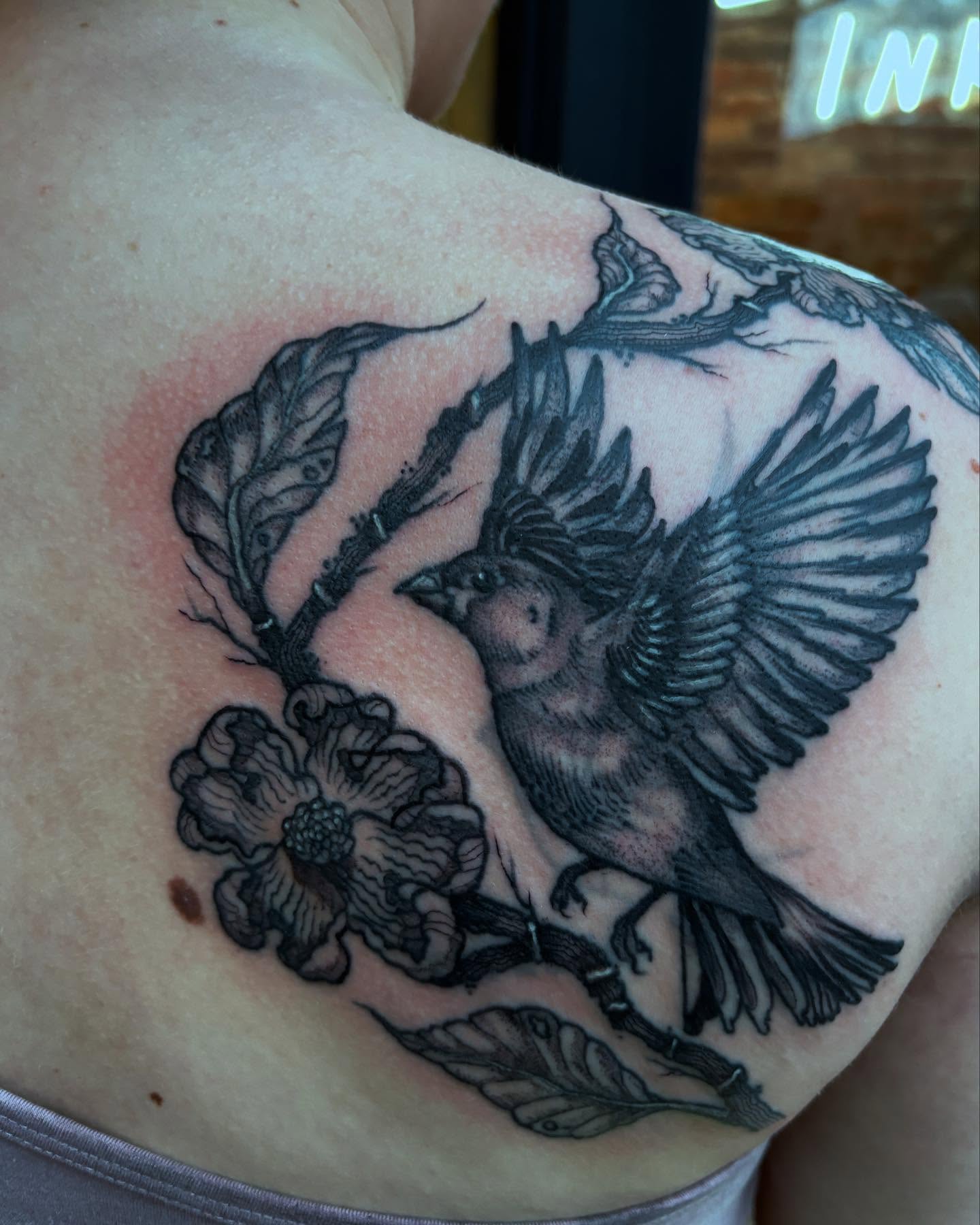 Bird and flower realism tattoo on the shoulder by kris noble floyd