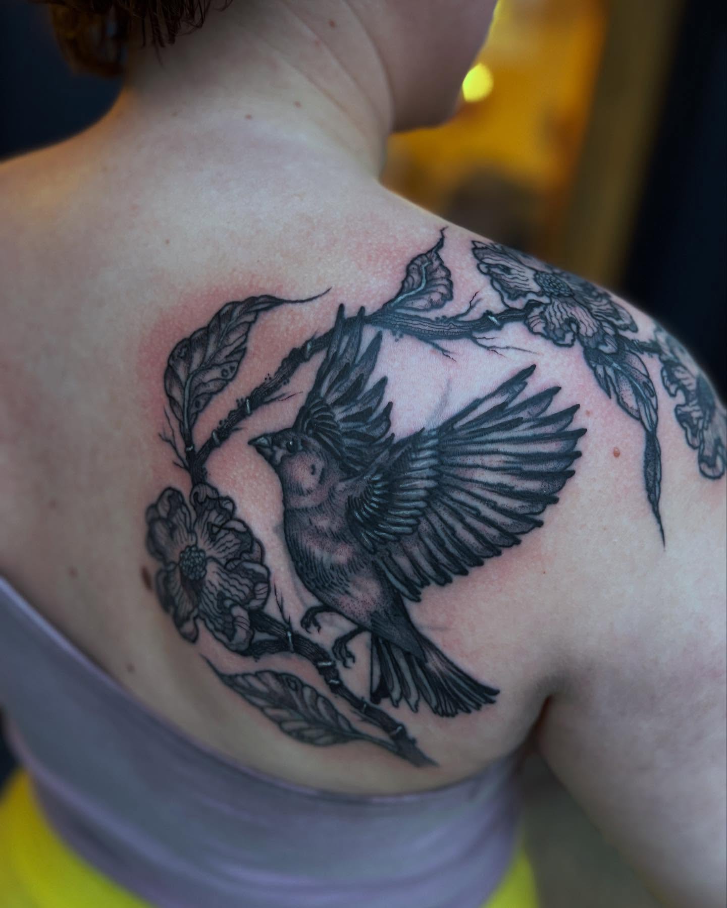 Bird and flowers black and grey tattoo on the shoulder by kris noble floyd