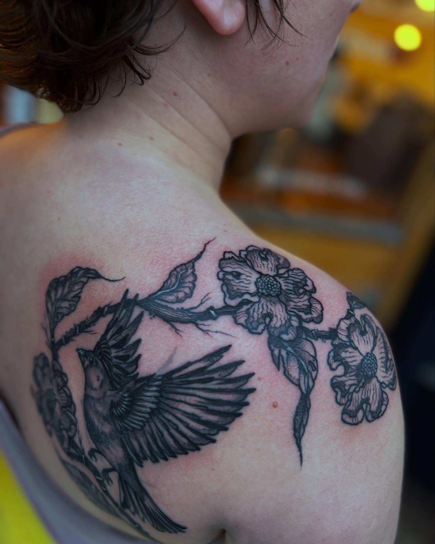 Bird and flowers black and grey tattoo on the shoulder by kris noble floyd