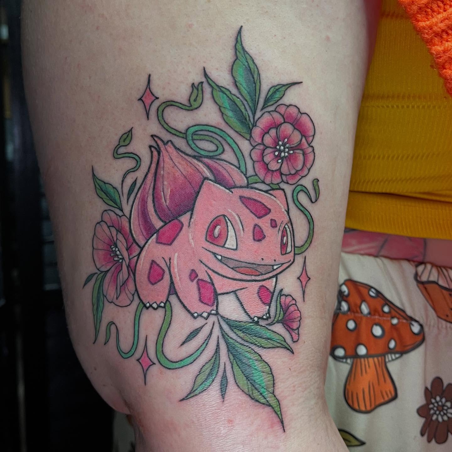 Bulbasaur with flowers new school tattoo on the thigh by Michigan Tattoo Artist - Nadia Garver, Clinton Township, Michigan