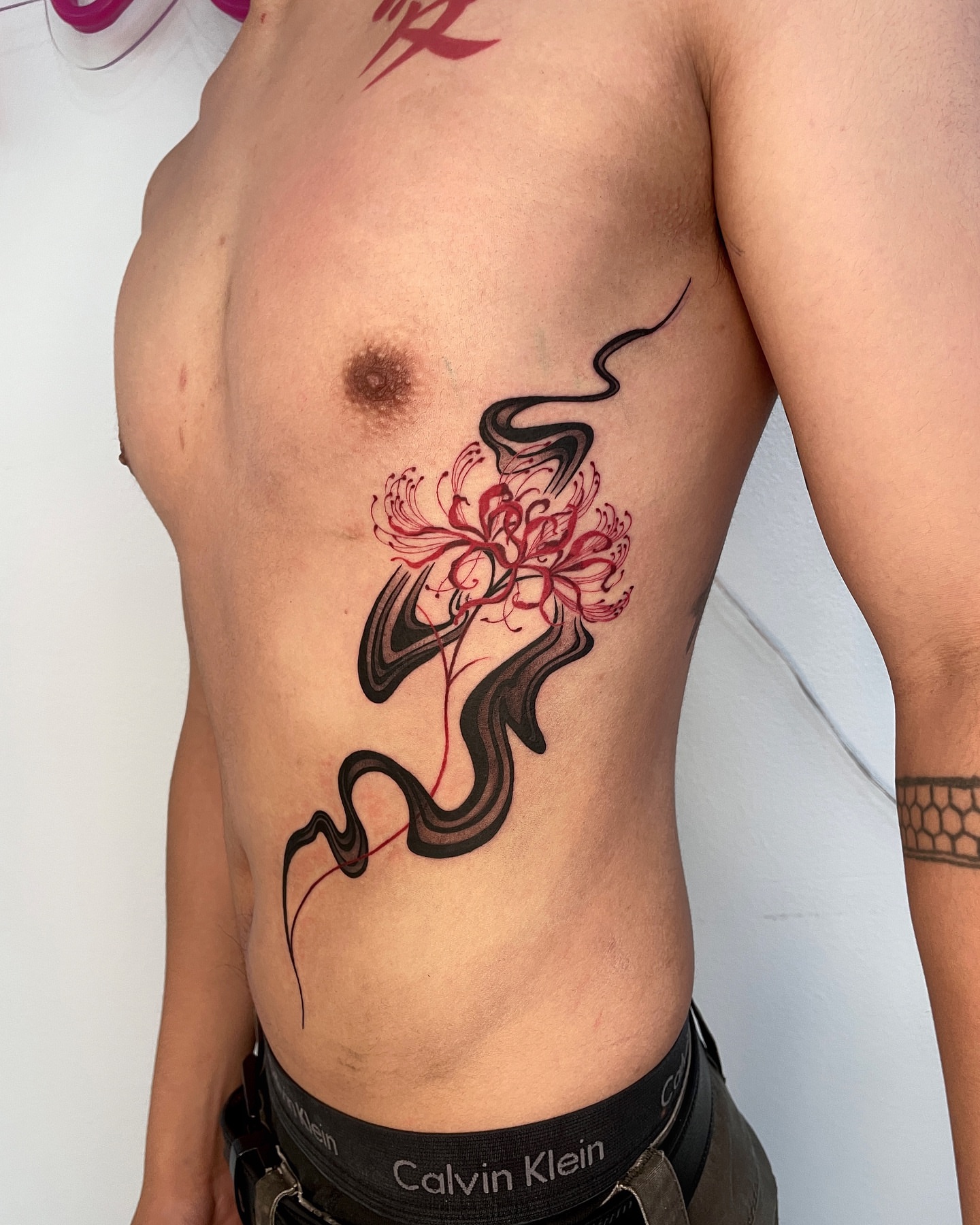 Flower and snake new school tattoo on the ribs by LA tattoo