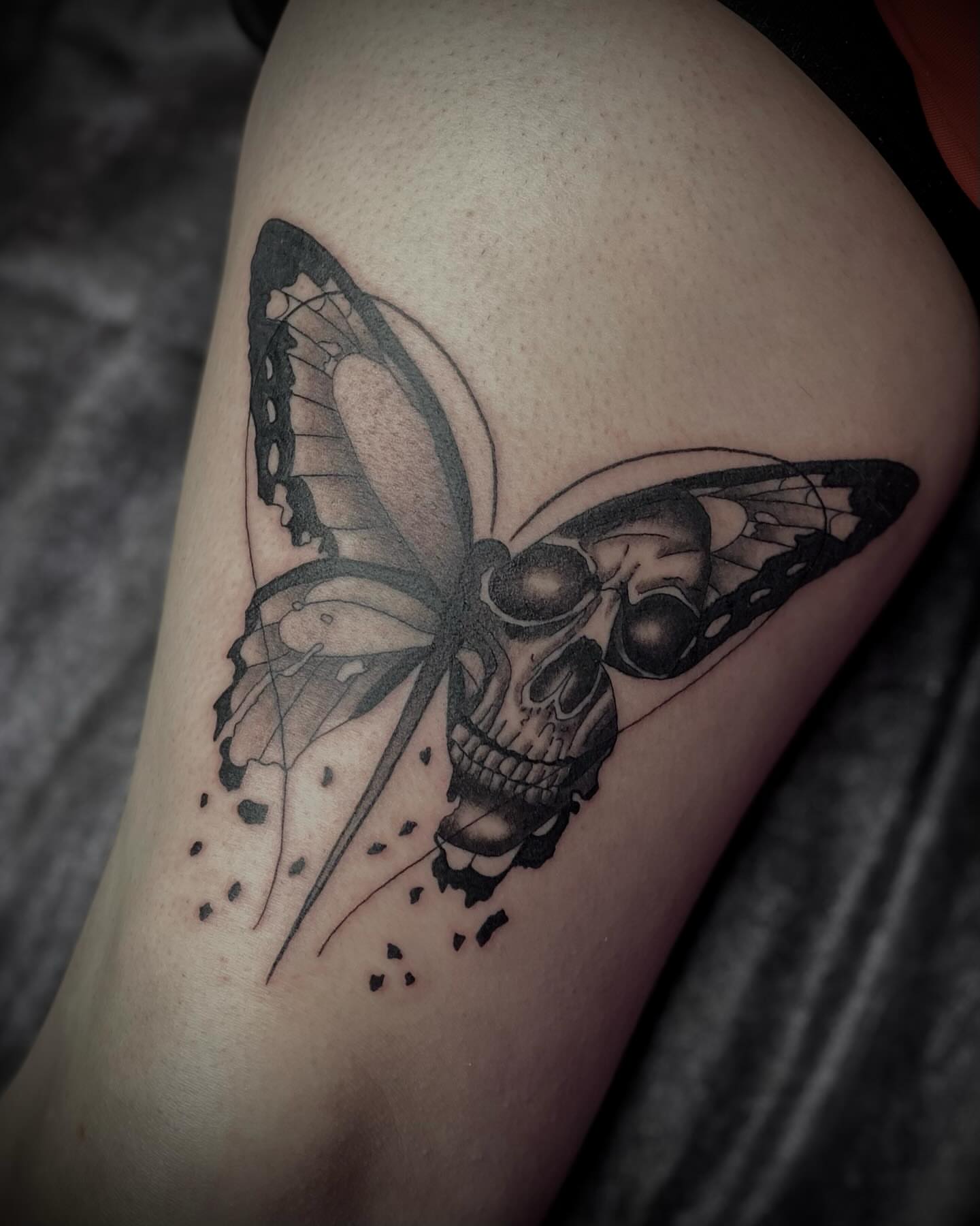 Butterfly skull dark realism tattoo on the thigh by Shelbie, Salt Lake City, Utah