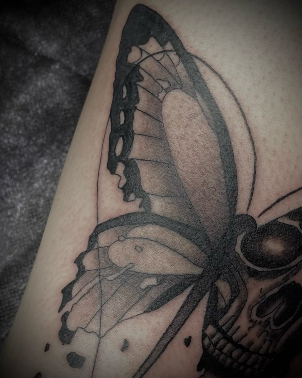 Butterfly and skull dark realism tattoo on the forearm by Shelbie, Salt Lake City, Utah