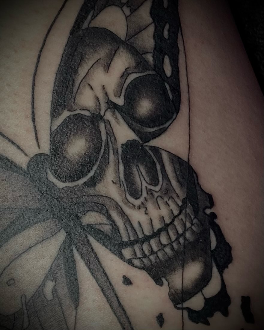 Skull and butterfly realism tattoo on the thigh by Shelbie, Salt Lake City, Utah