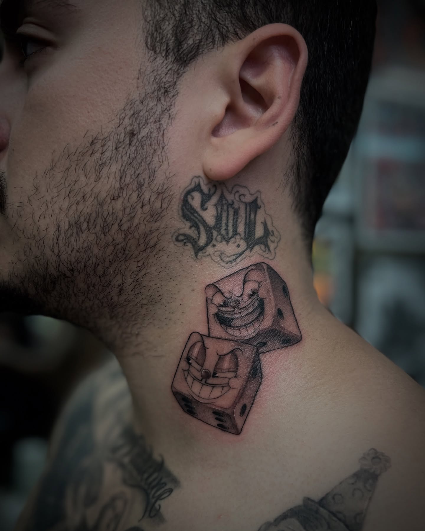 Dice black and grey tattoo on the neck by Valerie Dominguez