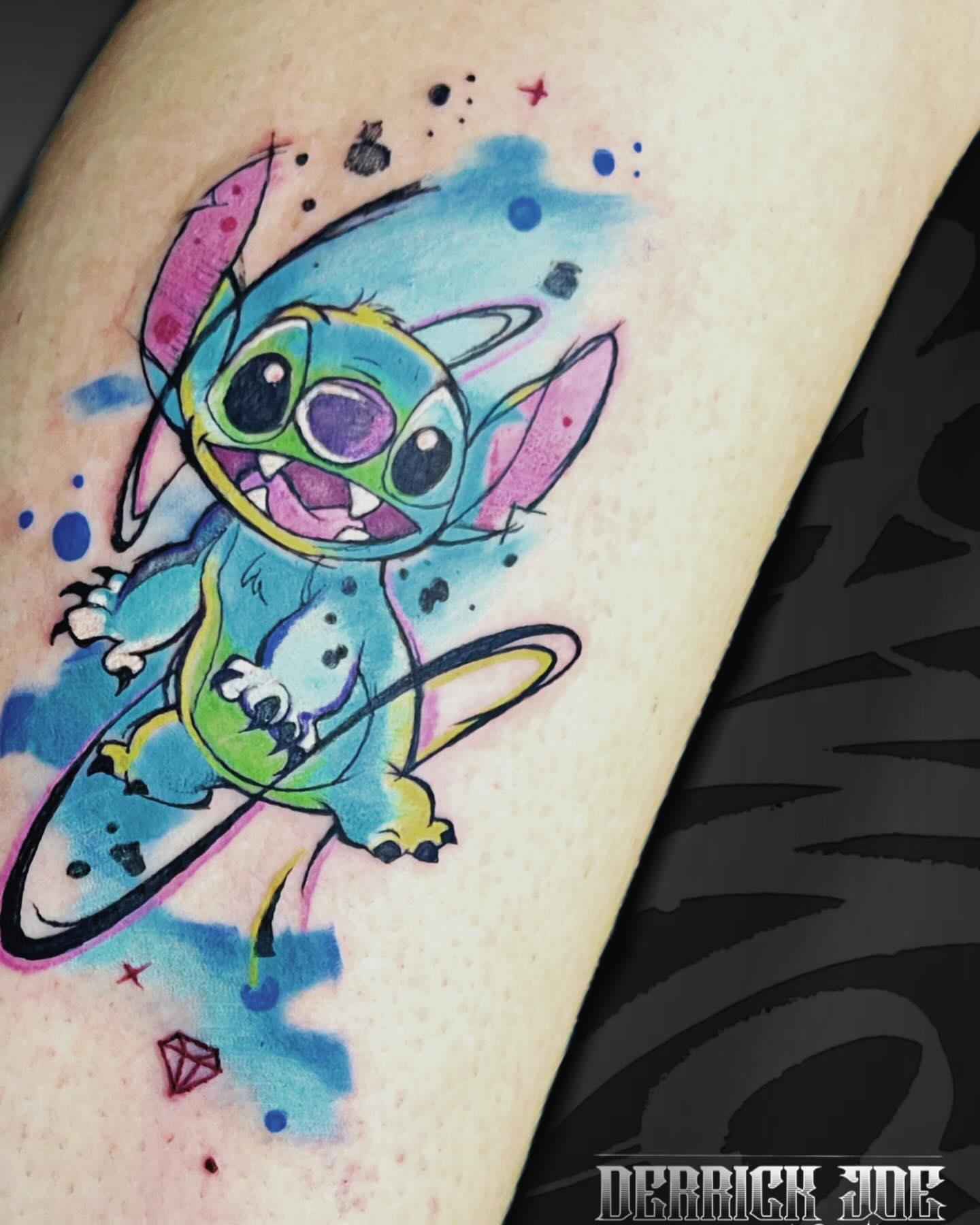 Stitch watercolor tattoo on the forearm by Derrick Joe tattoos