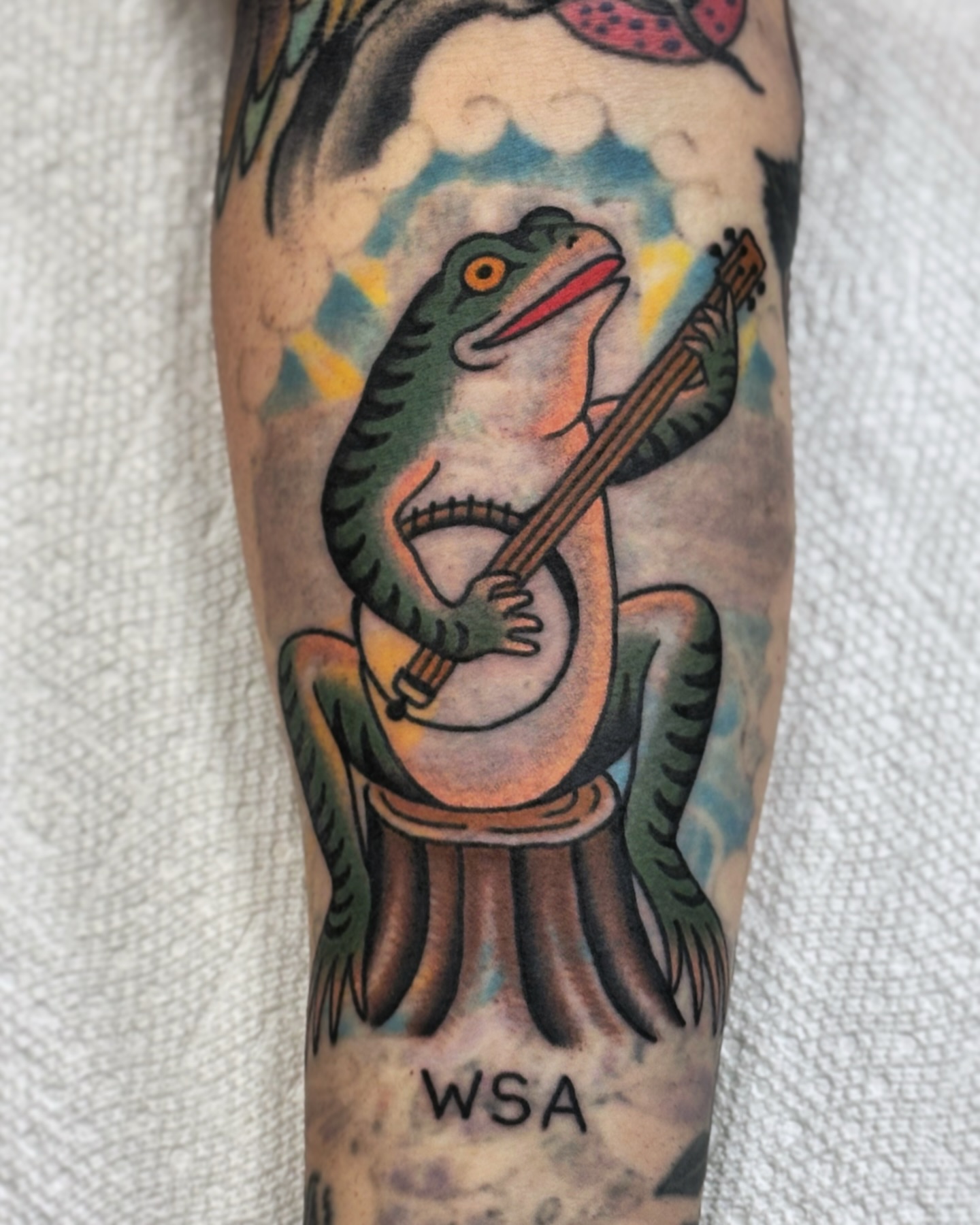 Alligator playing guitar American traditional tattoo on the forearm by Ben Fiedler