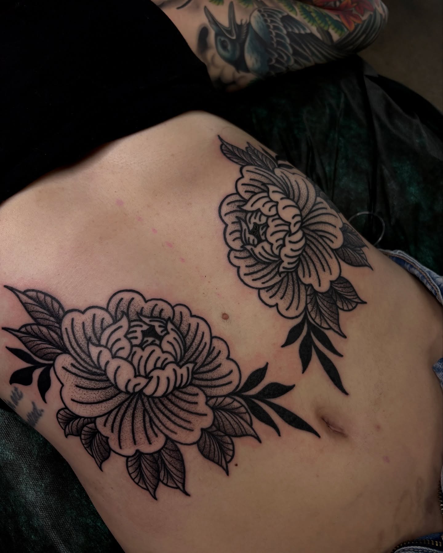 Peony flowers black and grey tattoo on the ribs by Kolbi Alexis