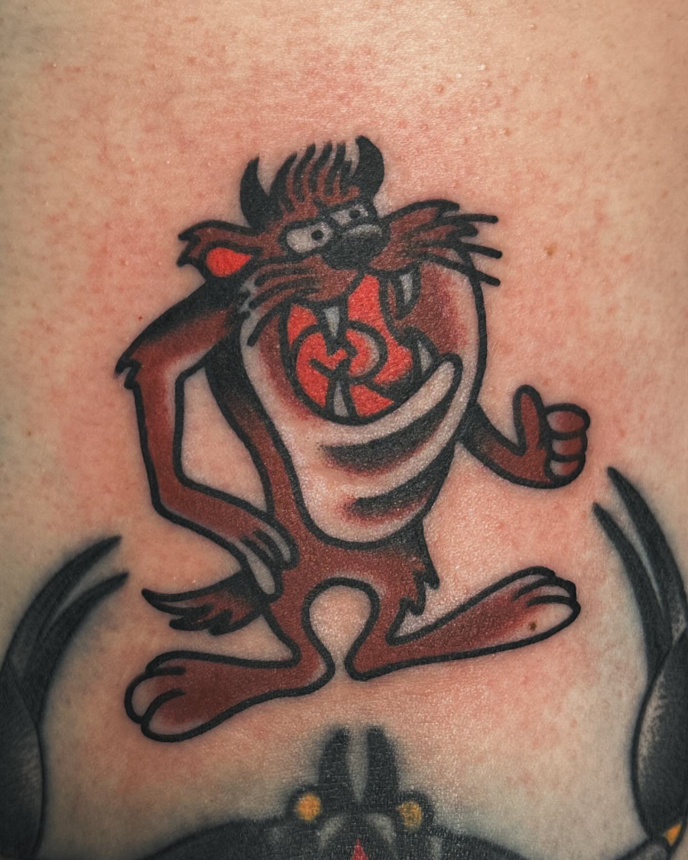 Tazmanian devil American traditional tattoo on the upper arm by Steve Pearson