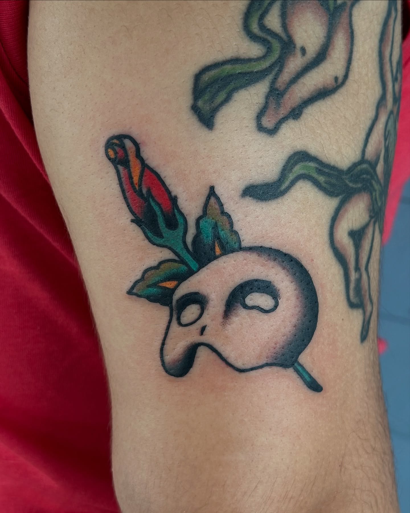 Skull with flowers American traditional tattoo on the forearm by Michael Williams