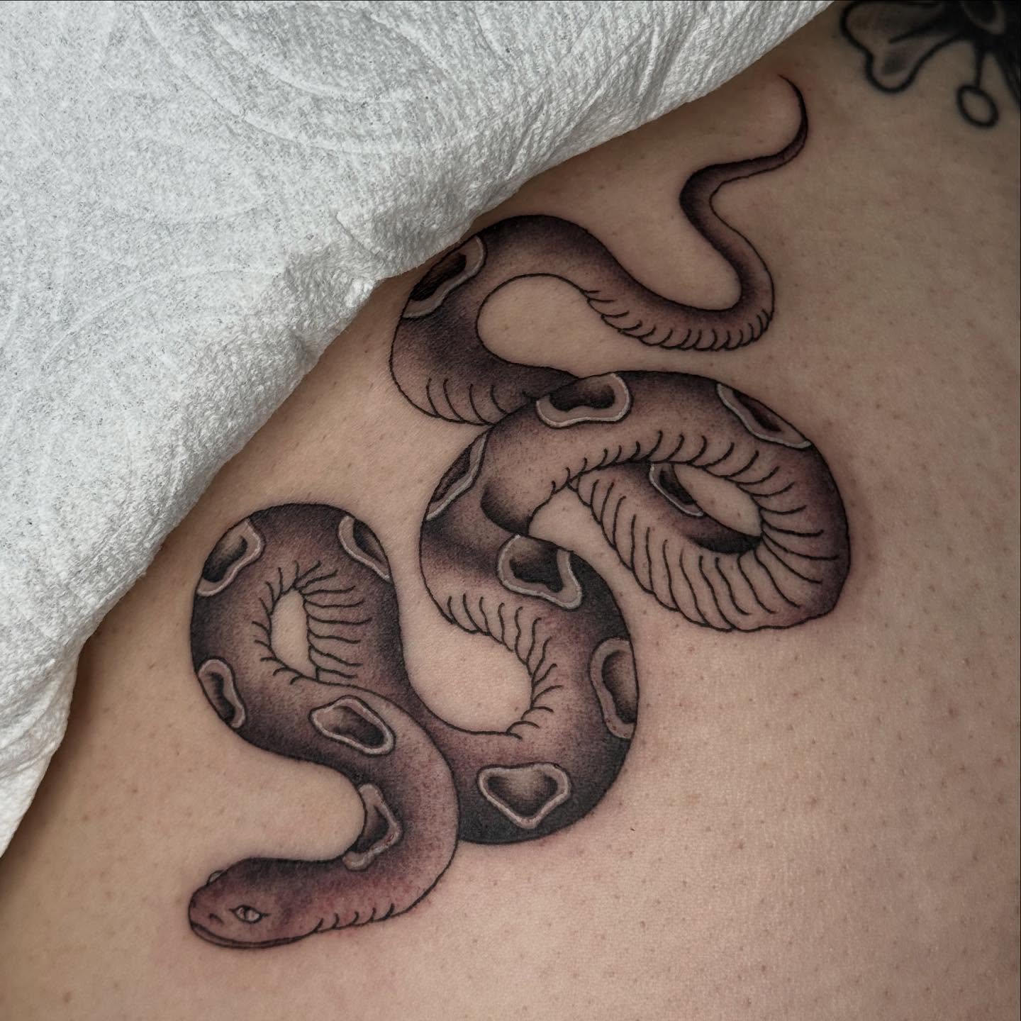 Snake black and grey tattoo on the shoulder by chloe jeanel estrada