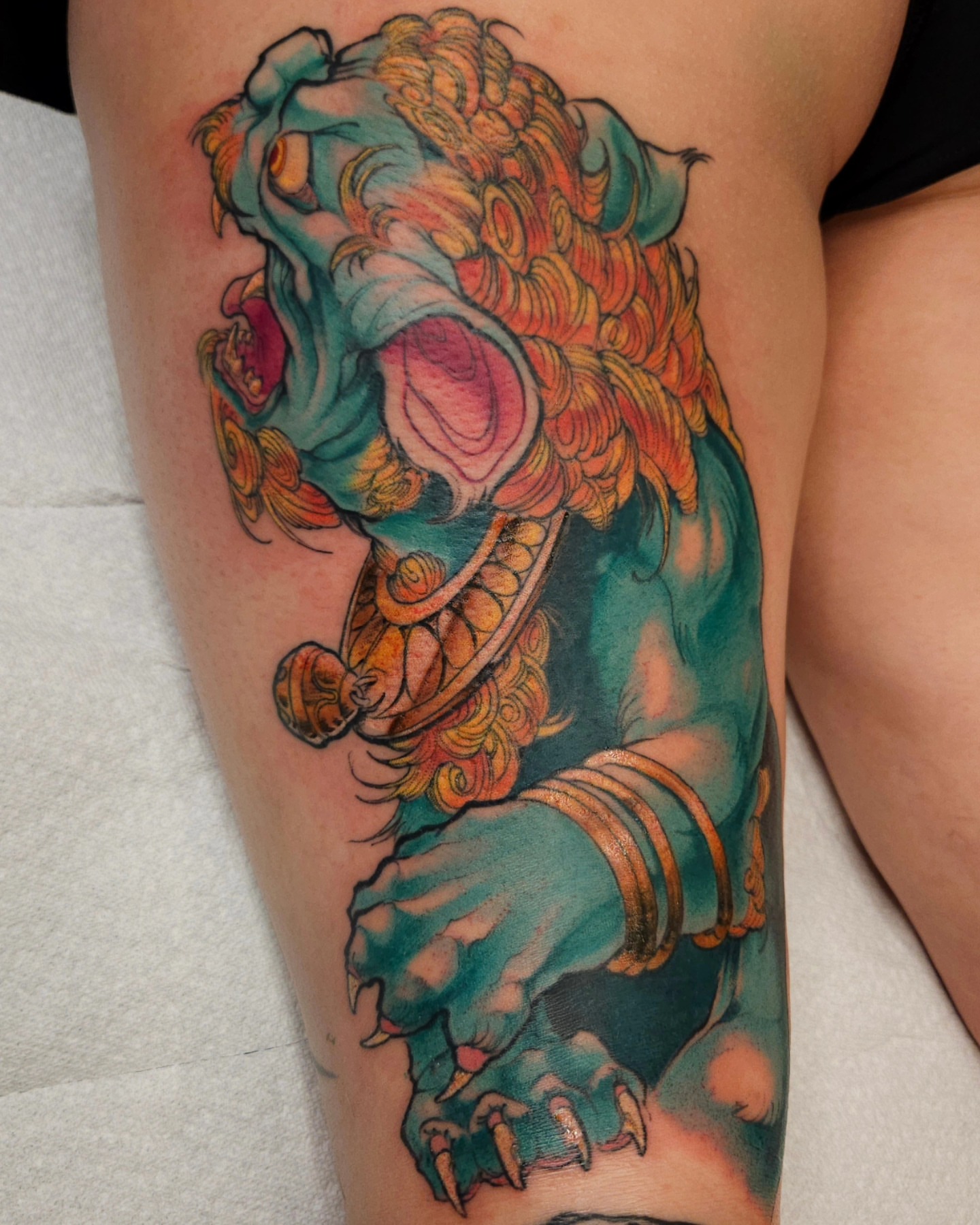 Lion American traditional tattoo on the thigh by Justin Byrd, Kansas City, Missouri