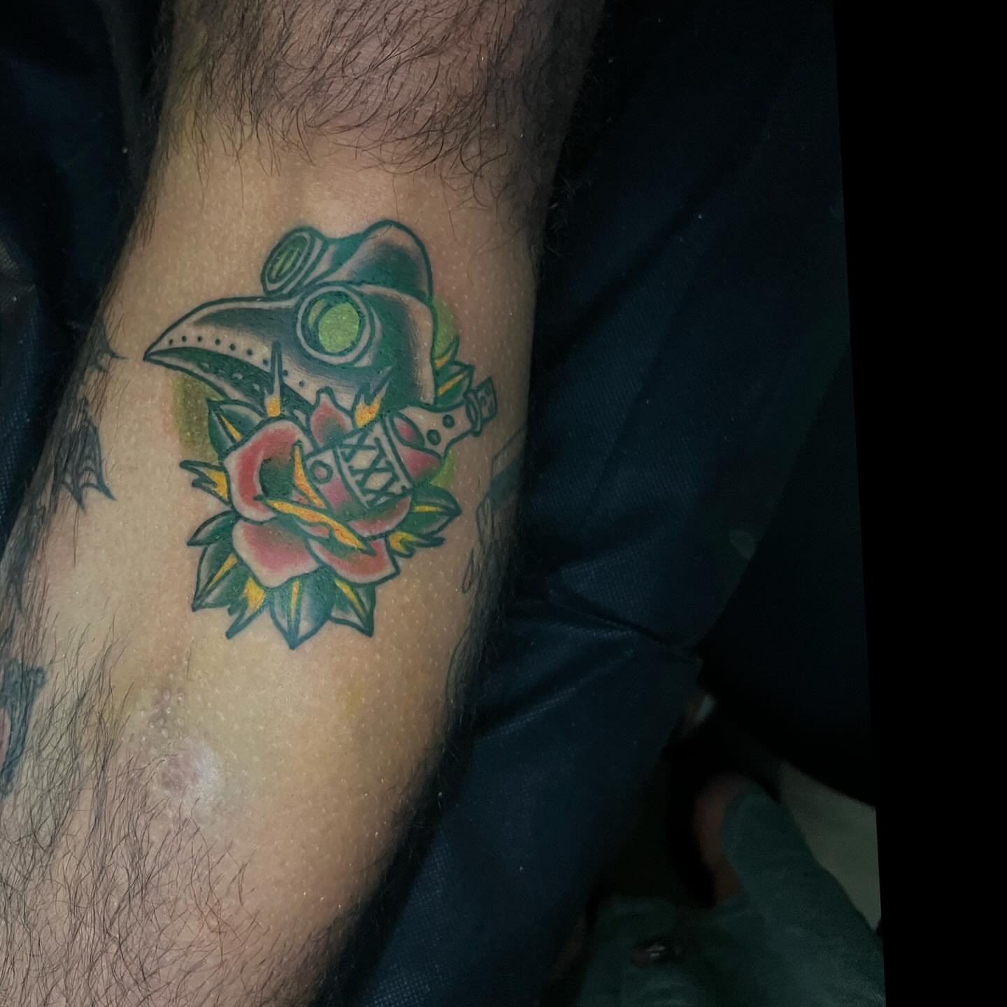 Plague doctor mask and rose American traditional tattoo on the forearm by Shelby Warren