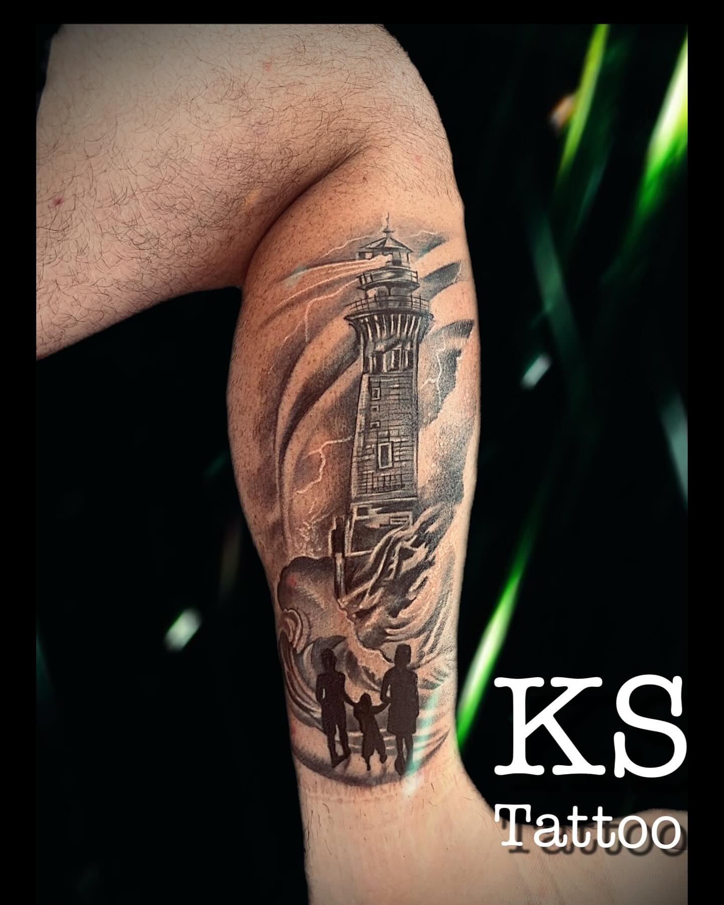 Lighthouse and family realism tattoo on the forearm by Karen Smith