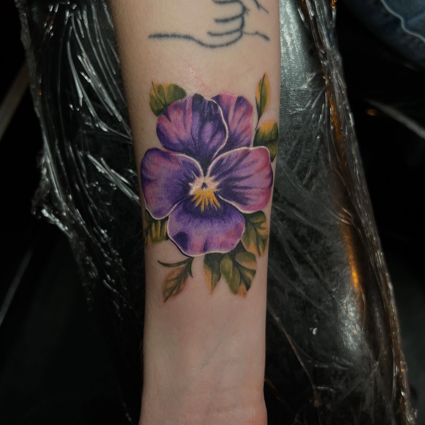 Purple pansy realism tattoo on the forearm by Brooke, Kansas City, Missouri