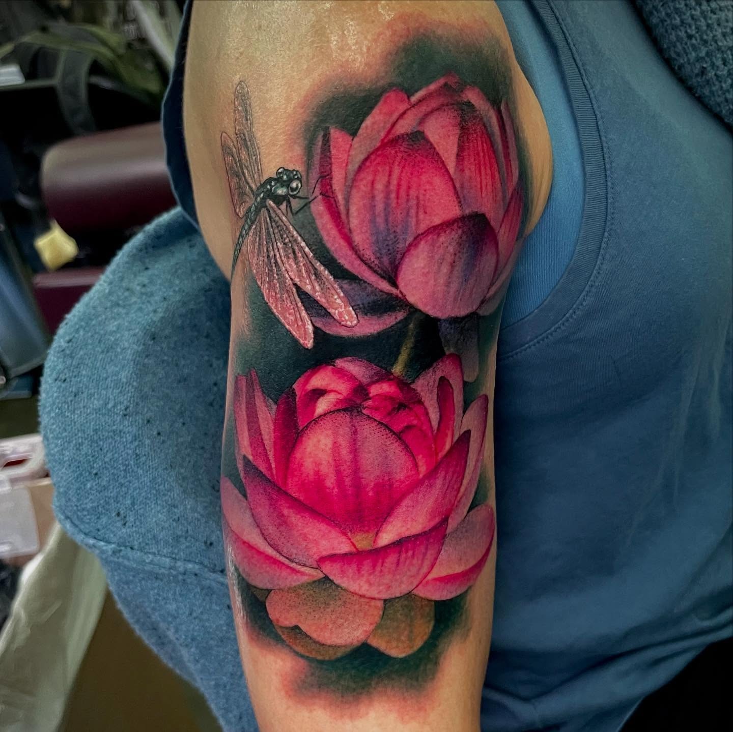 Lotus flowers and dragonfly realism tattoo on the forearm by Holli Marie