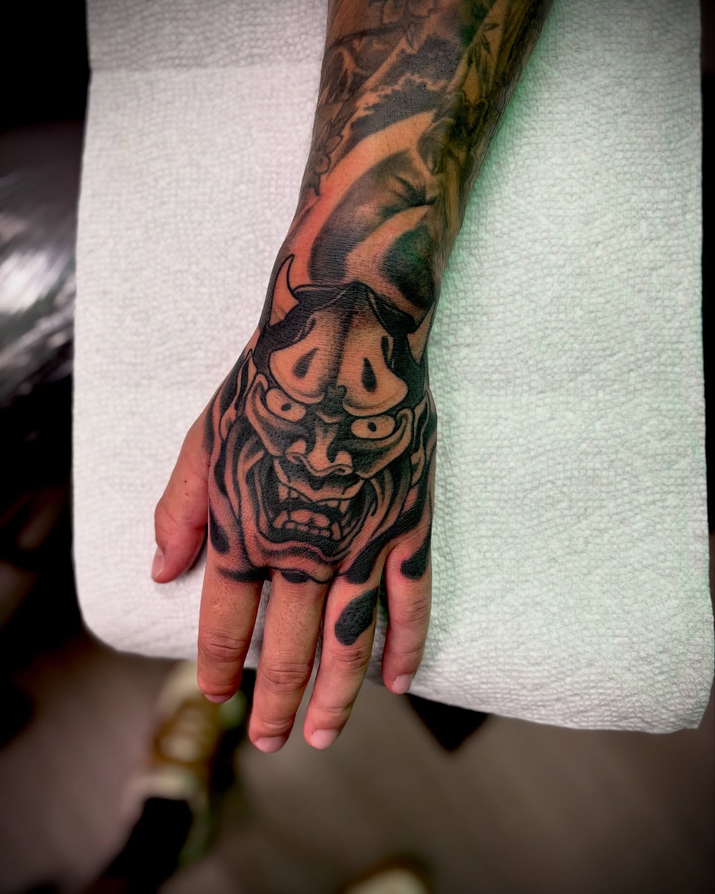 Japanese mask japanese irezumi tattoo on the hand by Ogden Tattoo Parlor