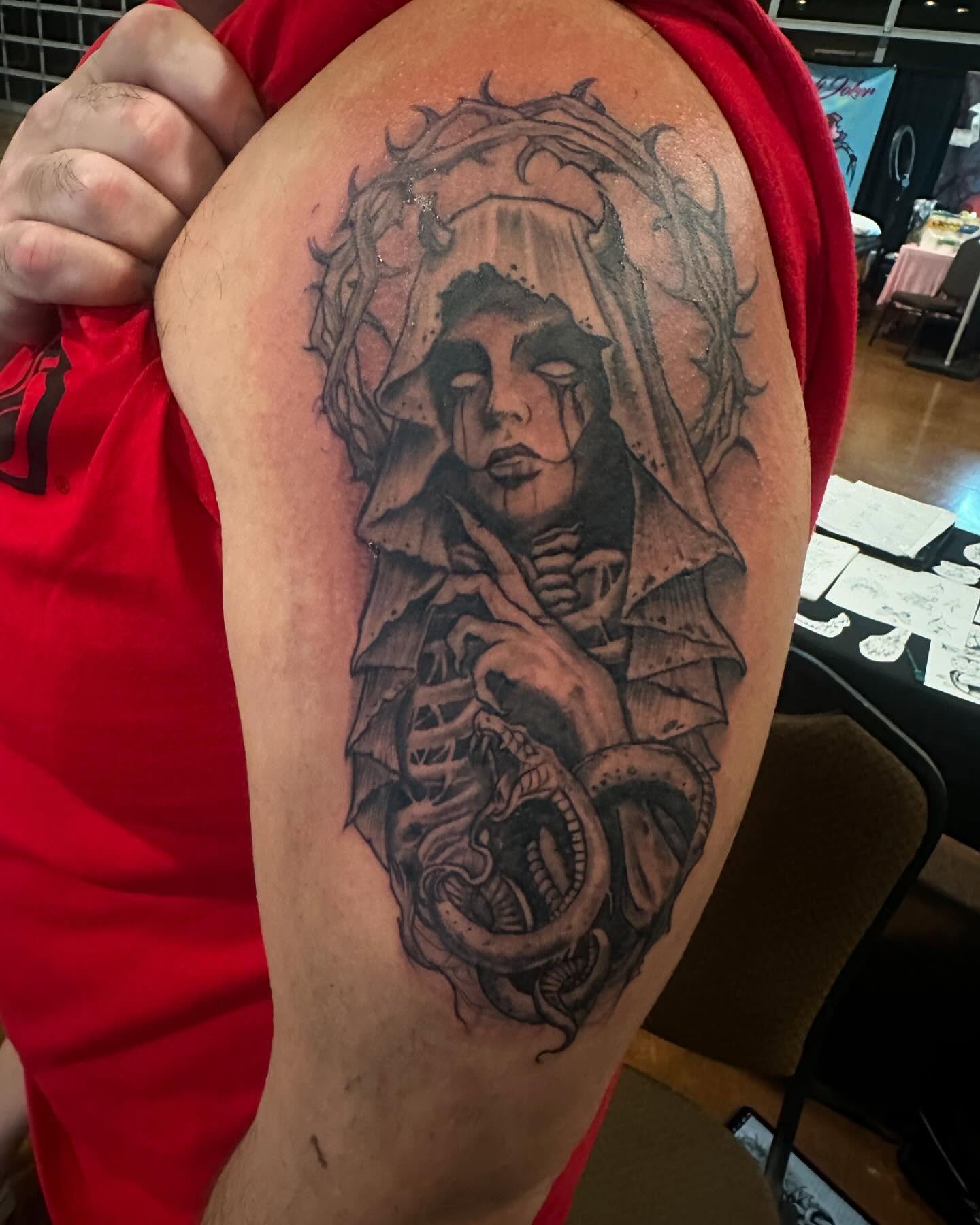 Woman with snake dark realism tattoo on the shoulder by Cyko Hernandez