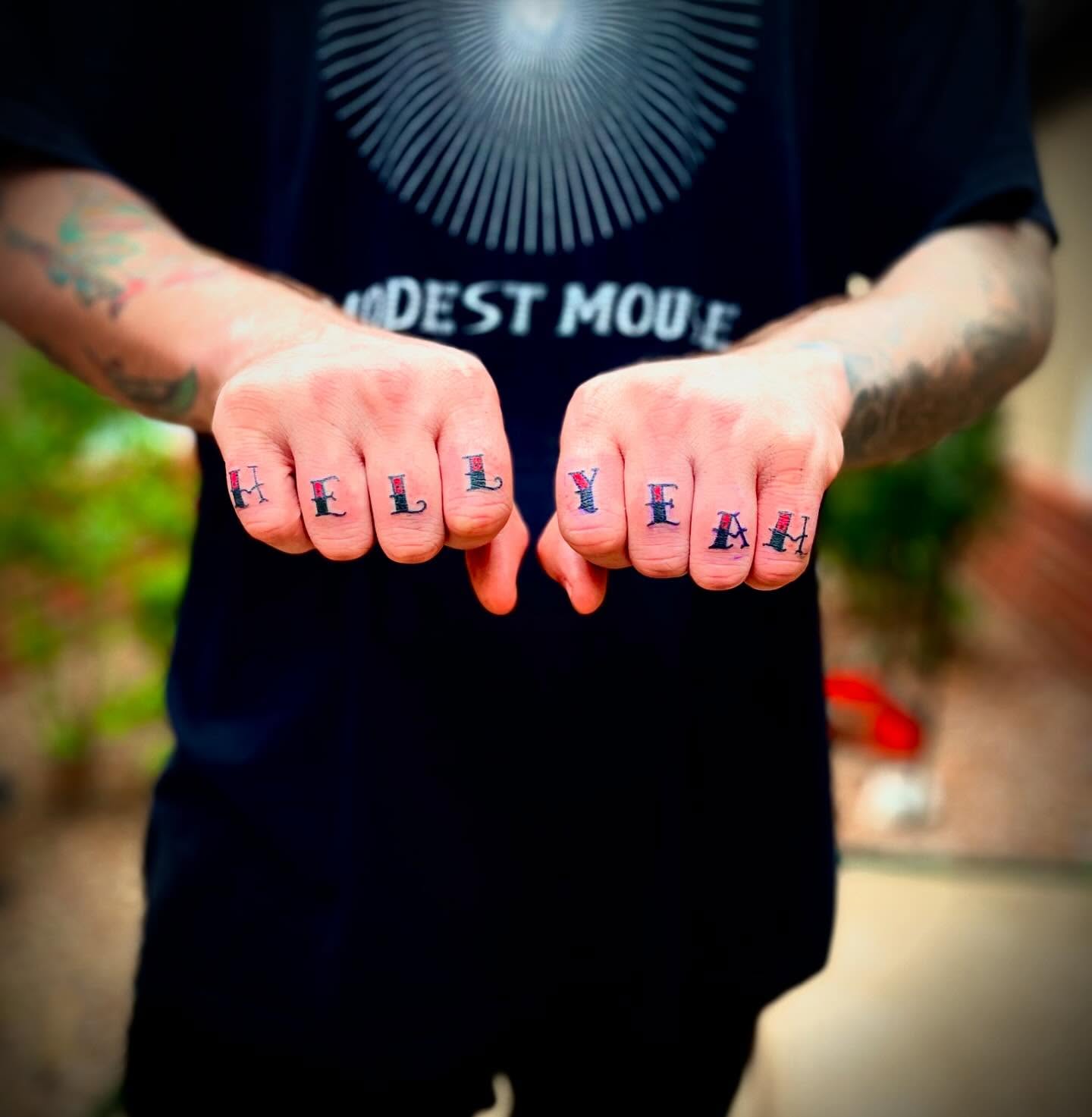 HELLO lettering script tattoo on the hand by JD Bassett