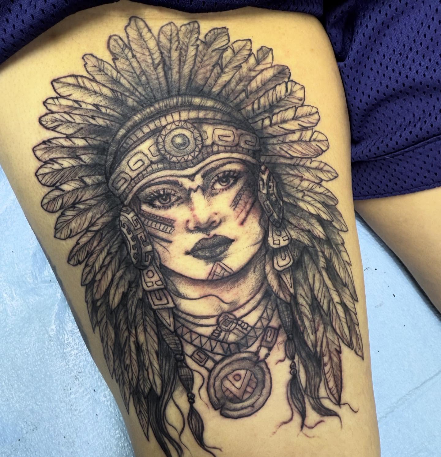 Indian headdress realism tattoo on the thigh by Tattoos By Trish