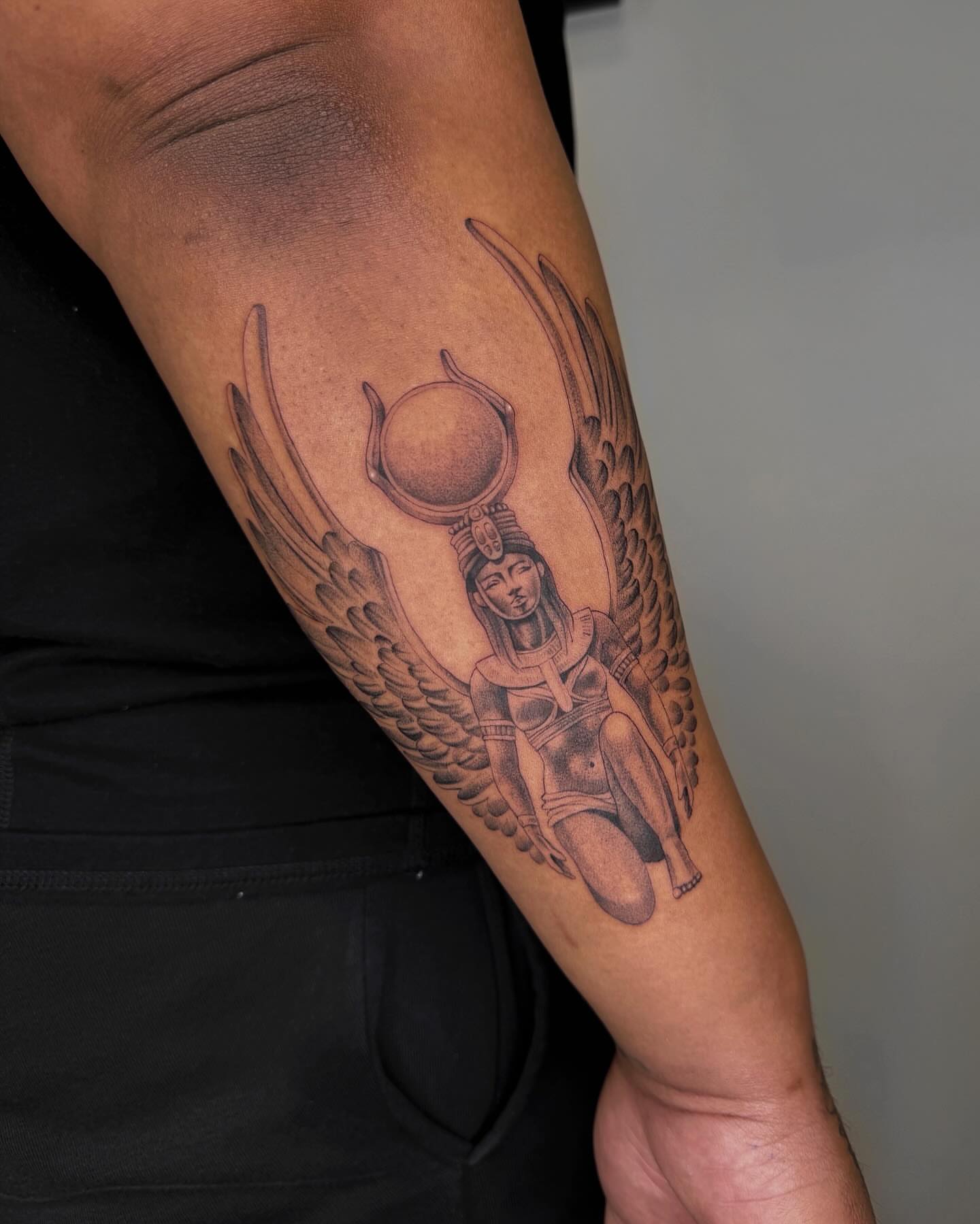 Winged goddess black and grey tattoo on the forearm by Alyssa . Villela