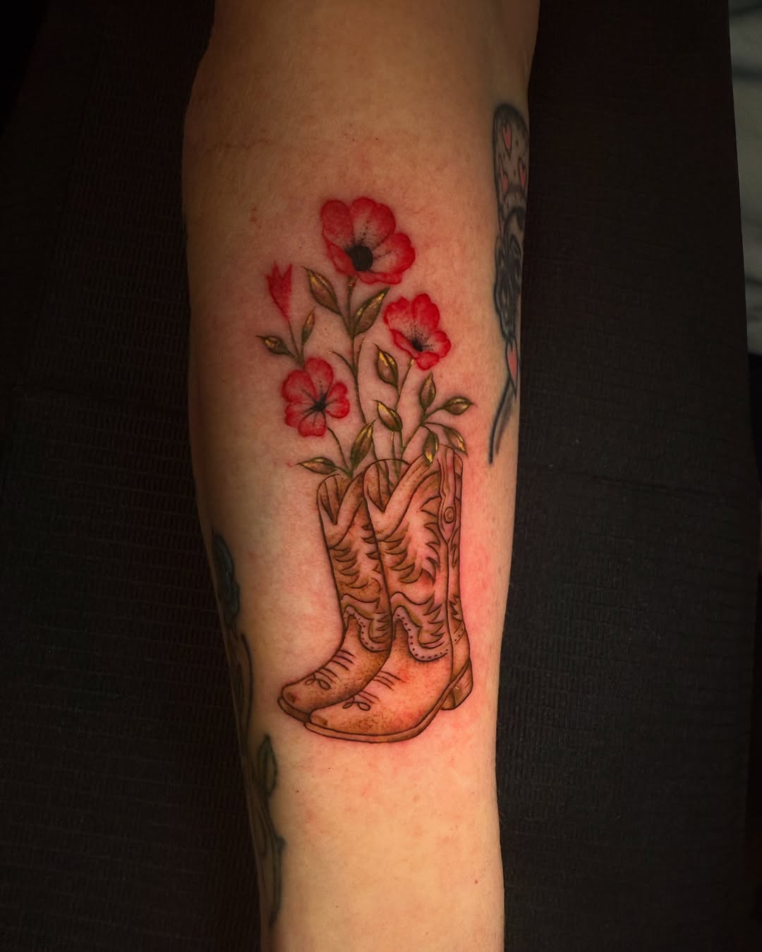 Cowboy boots with flowers neo-traditional tattoo on the forearm by Gabby Finearts