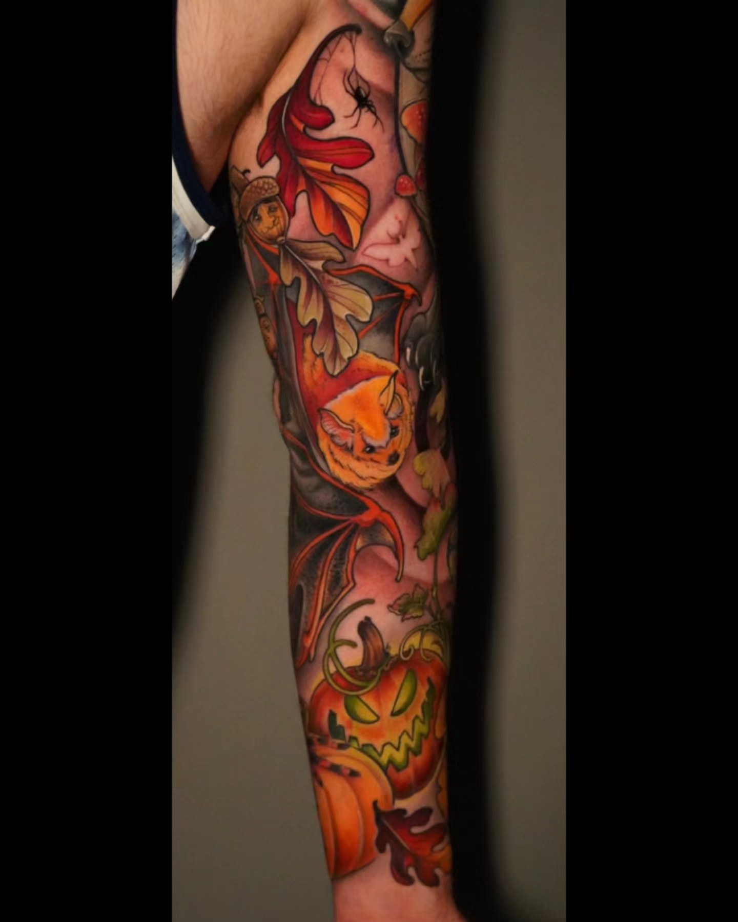 Pumpkins and autumn leaves American traditional tattoo on the forearm by Ashlynn Campbell