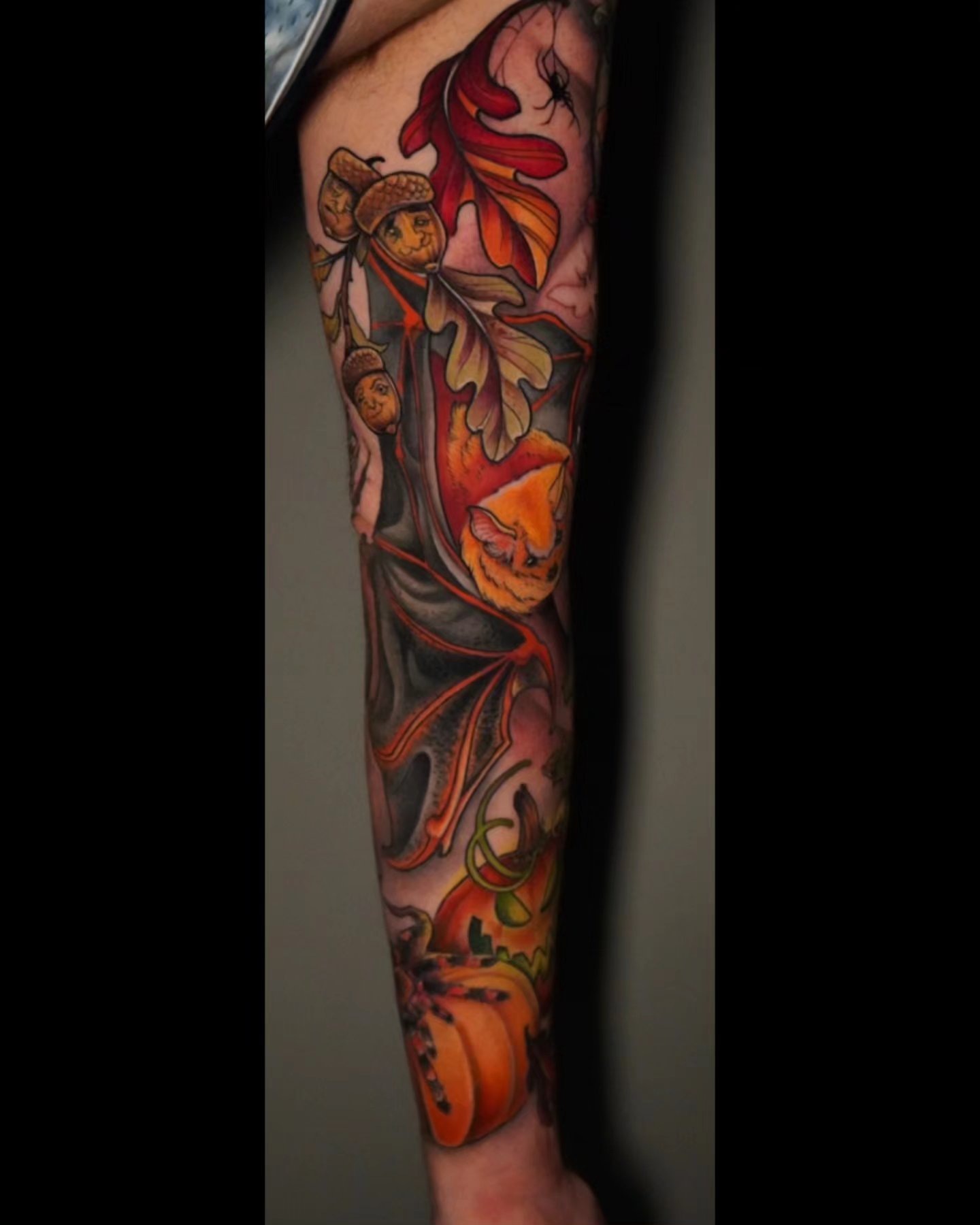Autumn leaves and pumpkins American traditional tattoo on the forearm by Ashlynn Campbell