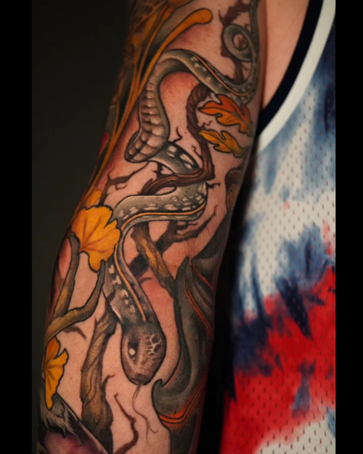 Snake and leaves American traditional tattoo on the forearm by Ashlynn Campbell