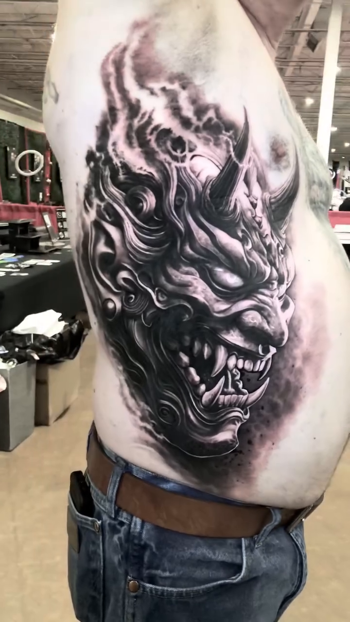 Demon mask dark realism tattoo by Lynn Hoang, Honolulu, Hawaii