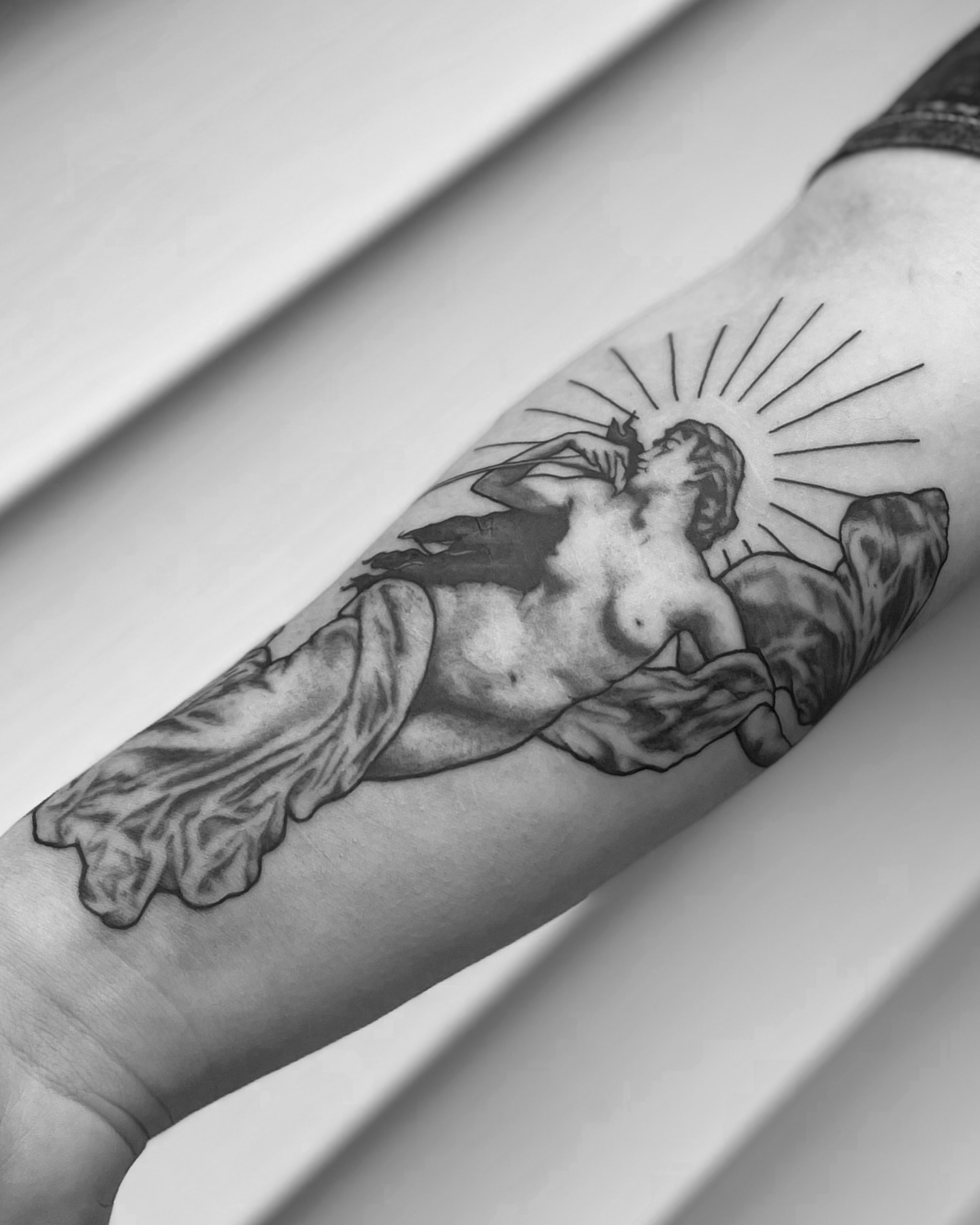 Statue black and grey tattoo on the forearm by Liv