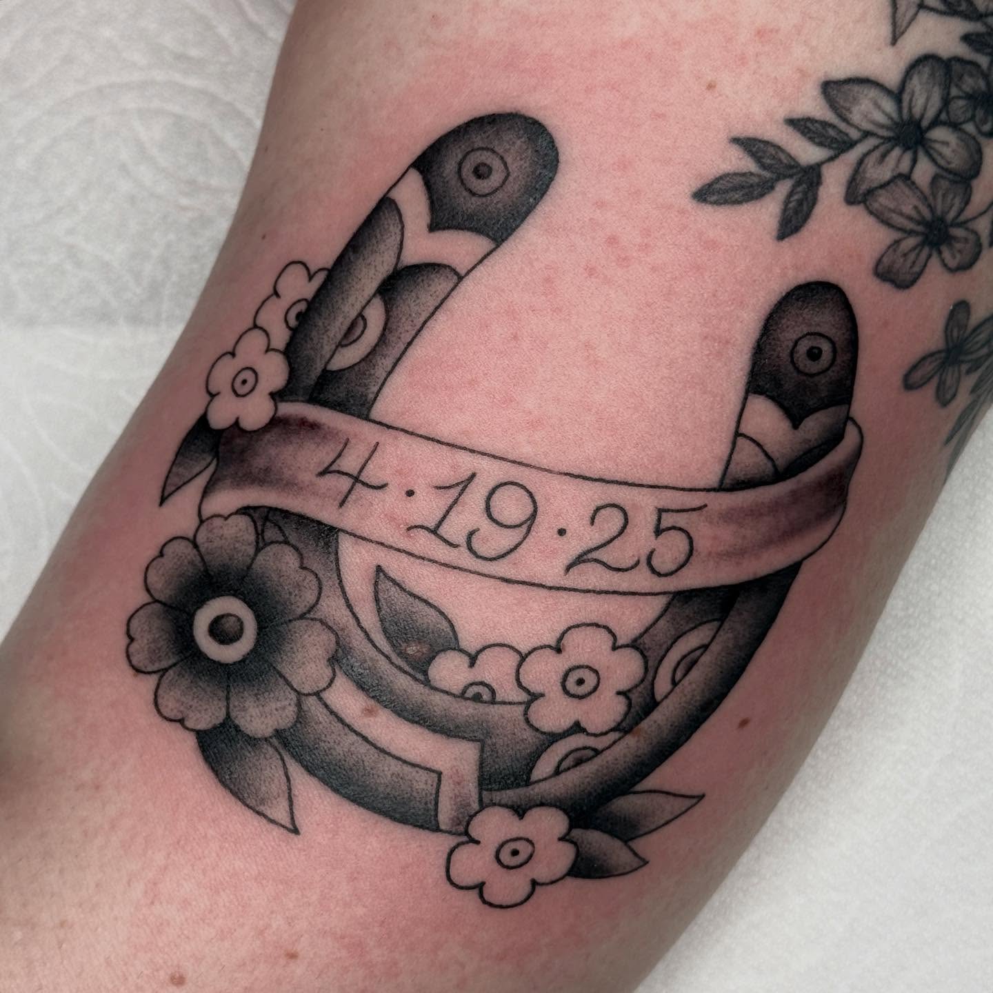 Bird and ribbon black and grey tattoo on the forearm by chloe jeanel estrada