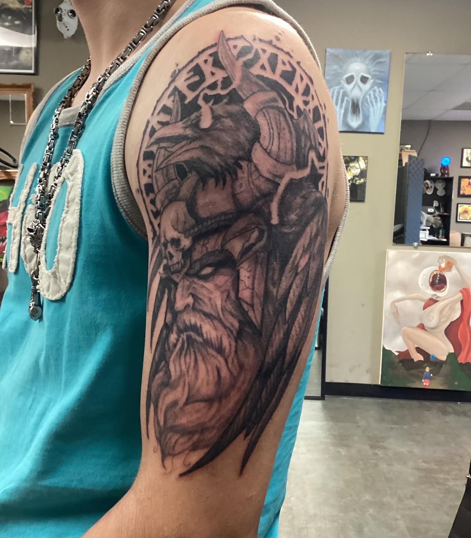 Viking warrior with raven and skull realism tattoo on the shoulder by Russell Lucas