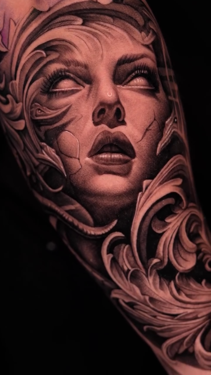 A woman's face with ornate scrollwork realism tattoo by Steven tattoo