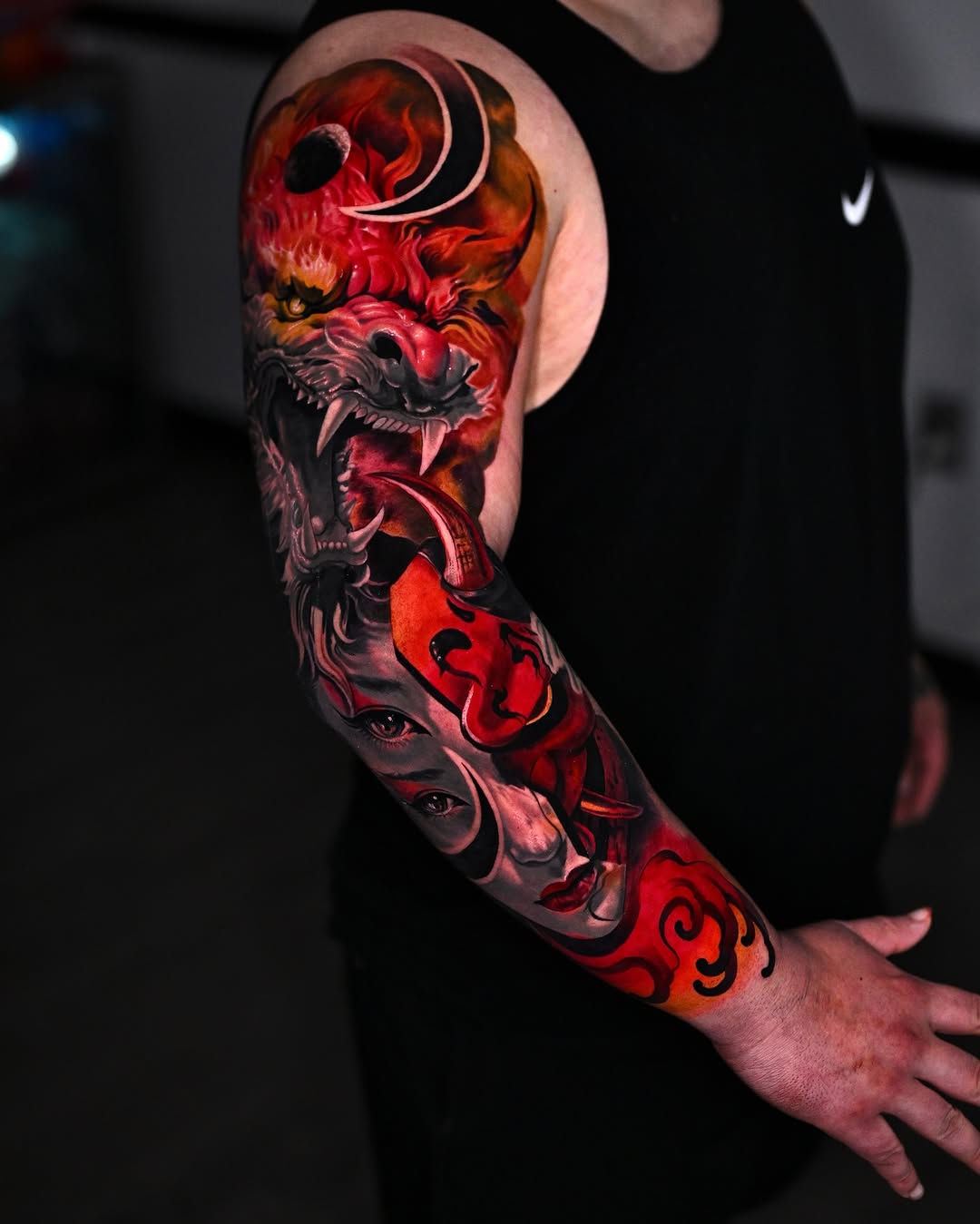 Demon wolf and faces Japanese tattoo on the upper arm by Marcos Salamanca