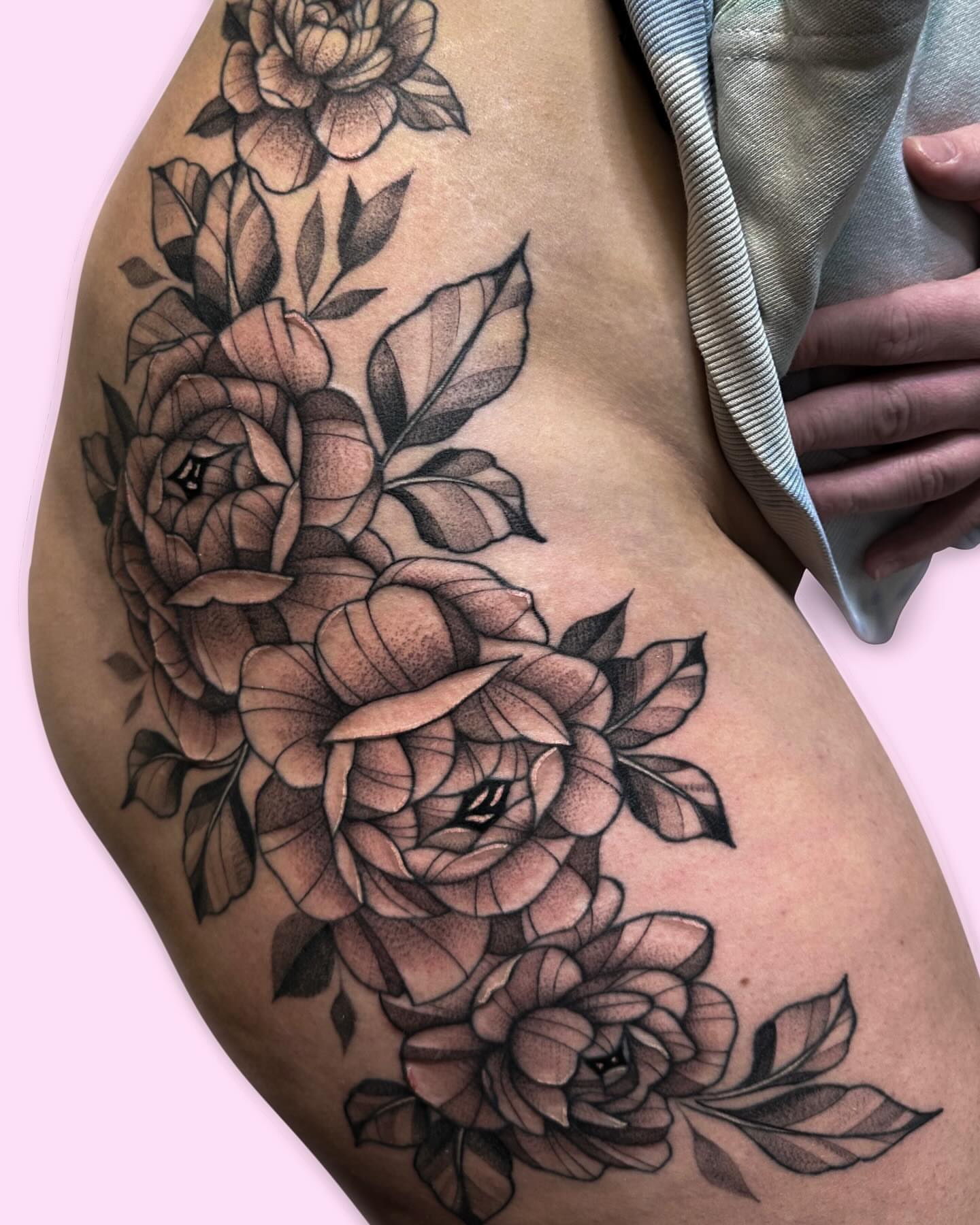 Roses black and grey tattoo on the thigh by Gabby Tolley🌛