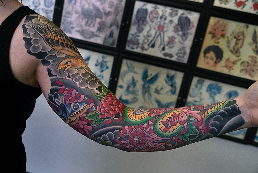 Eagle and floral American traditional tattoo on the forearm by Erick Lynch, Cambridge, Massachusetts