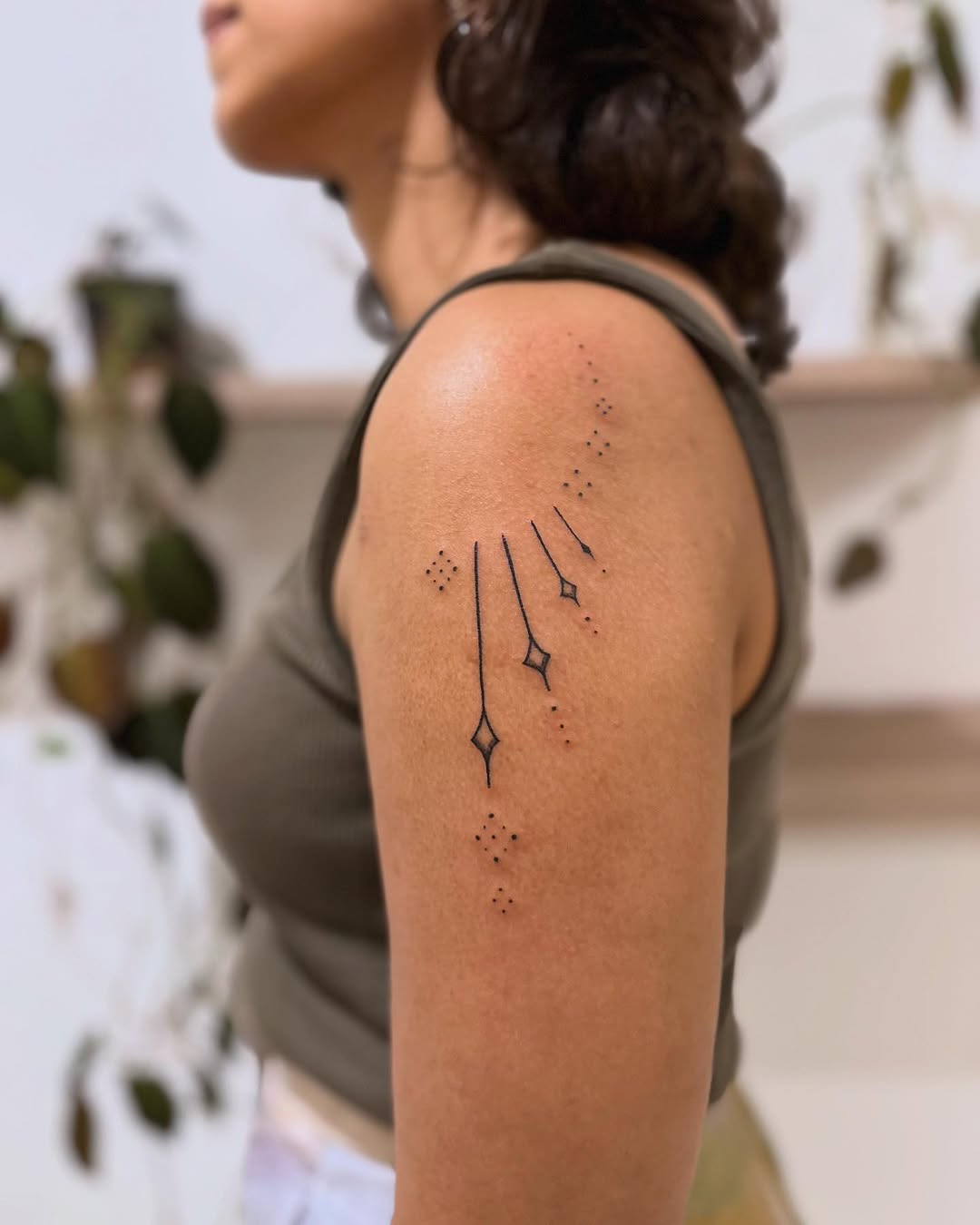 Geometric stars and dots ornamental tattoo on the shoulder by Gaya