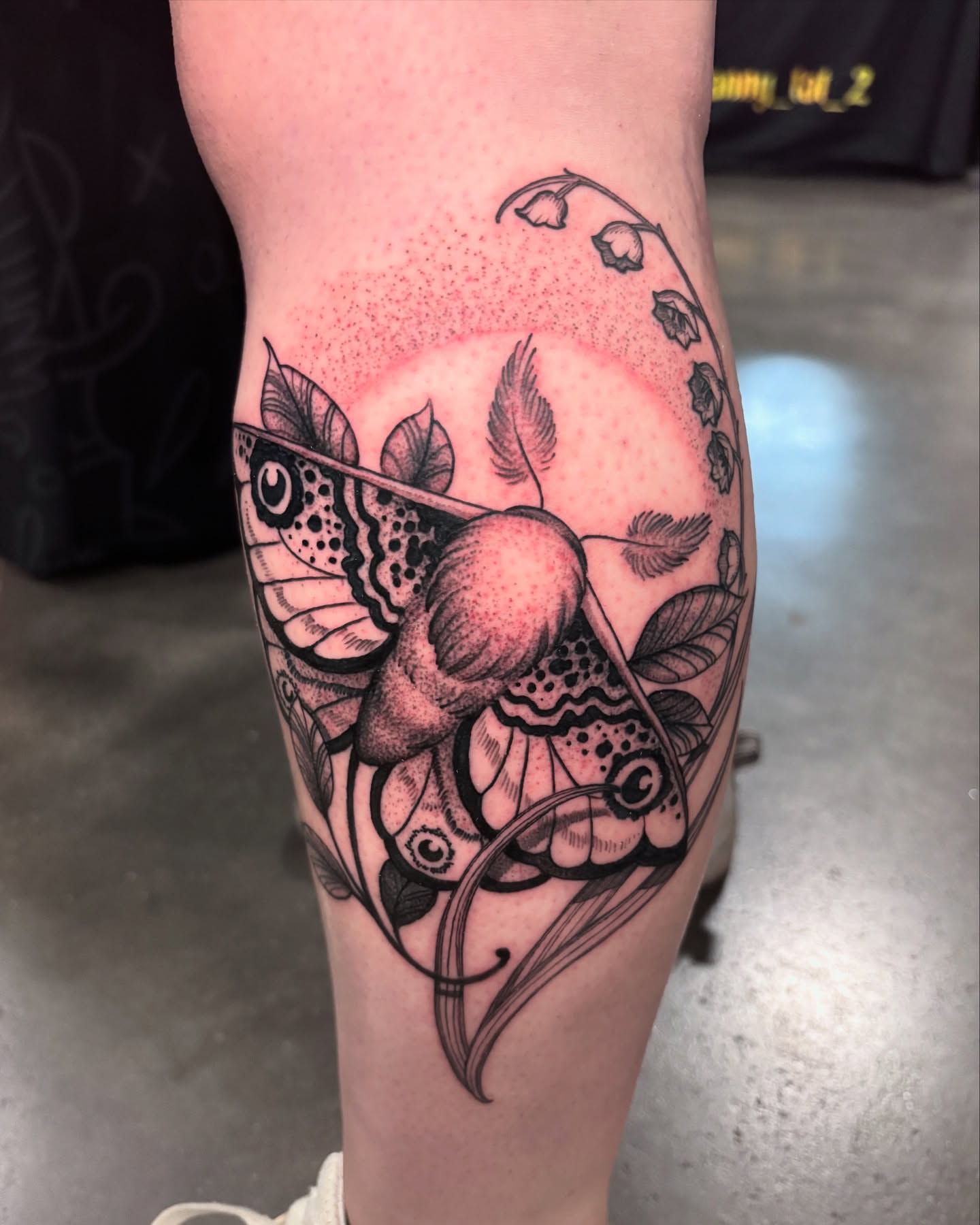 Butterfly and flowers dotwork tattoo on the calf by Carol Jacky