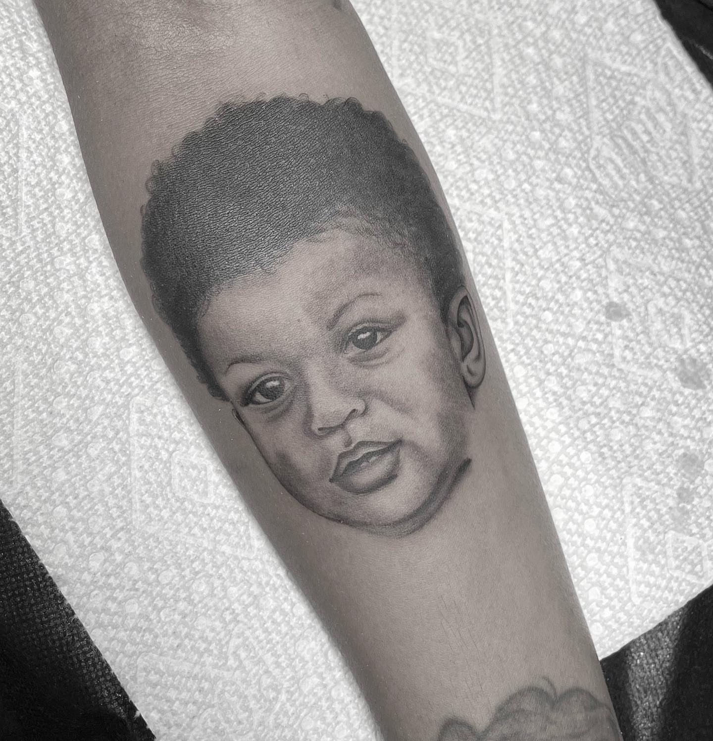 Child portrait realism tattoo on the forearm by Kayla Faircloth, Charlotte, North Carolina