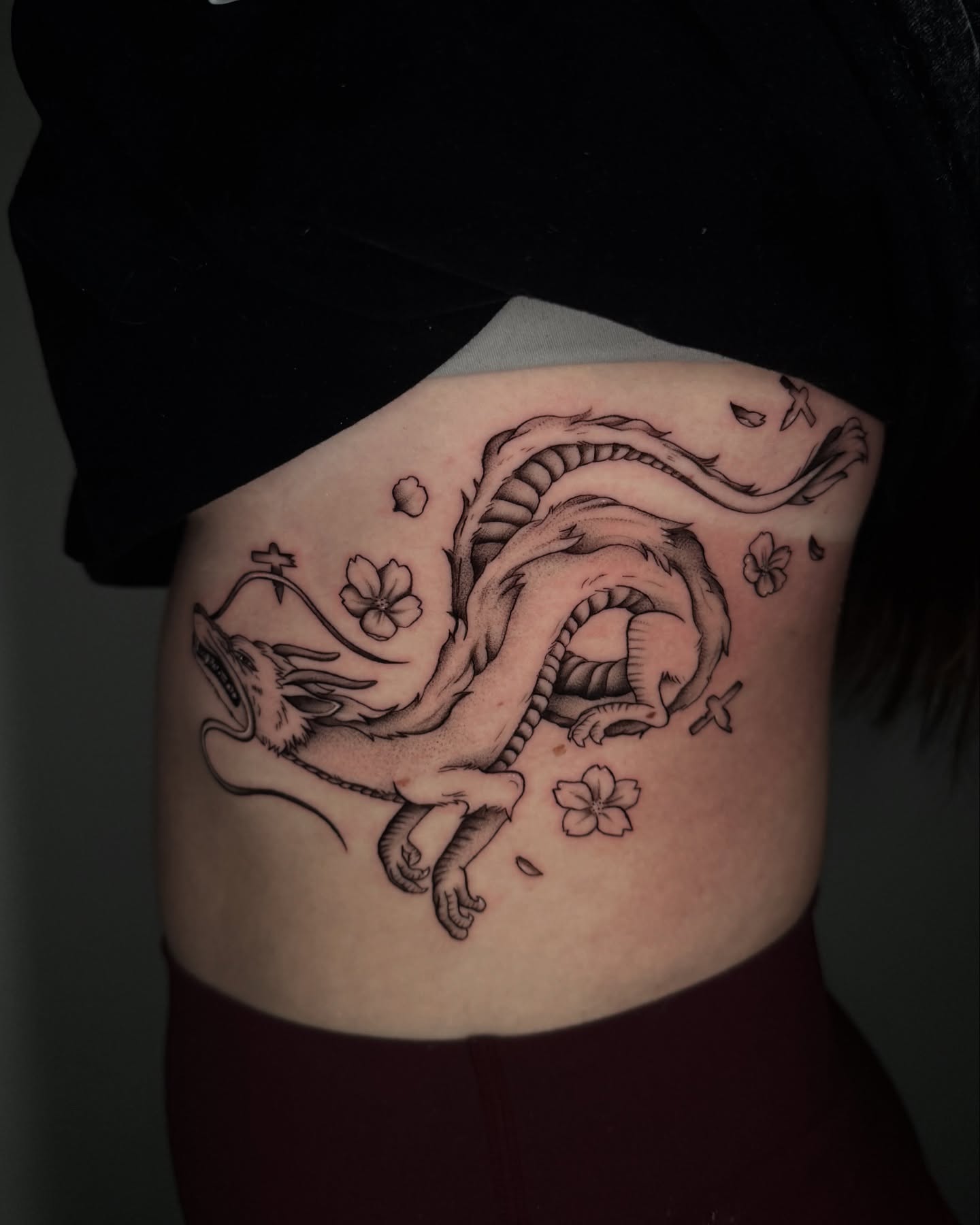 Dragon black and grey tattoo on the ribs by kelsey hackett
