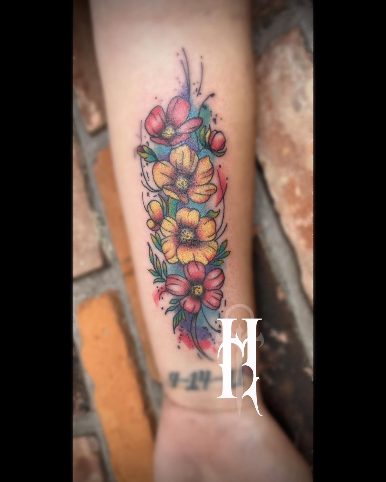 Floral arrangement watercolor tattoo on the forearm by Tattoos by Dan Hatcher Carr, Parma, Ohio